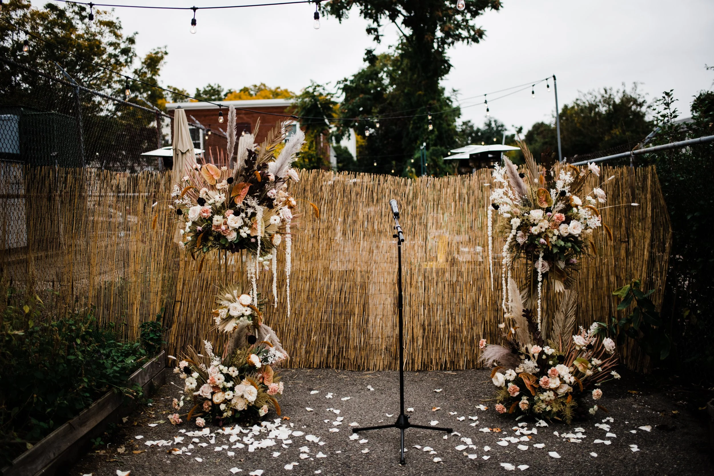 Outdoor wedding altar scattered flower petals