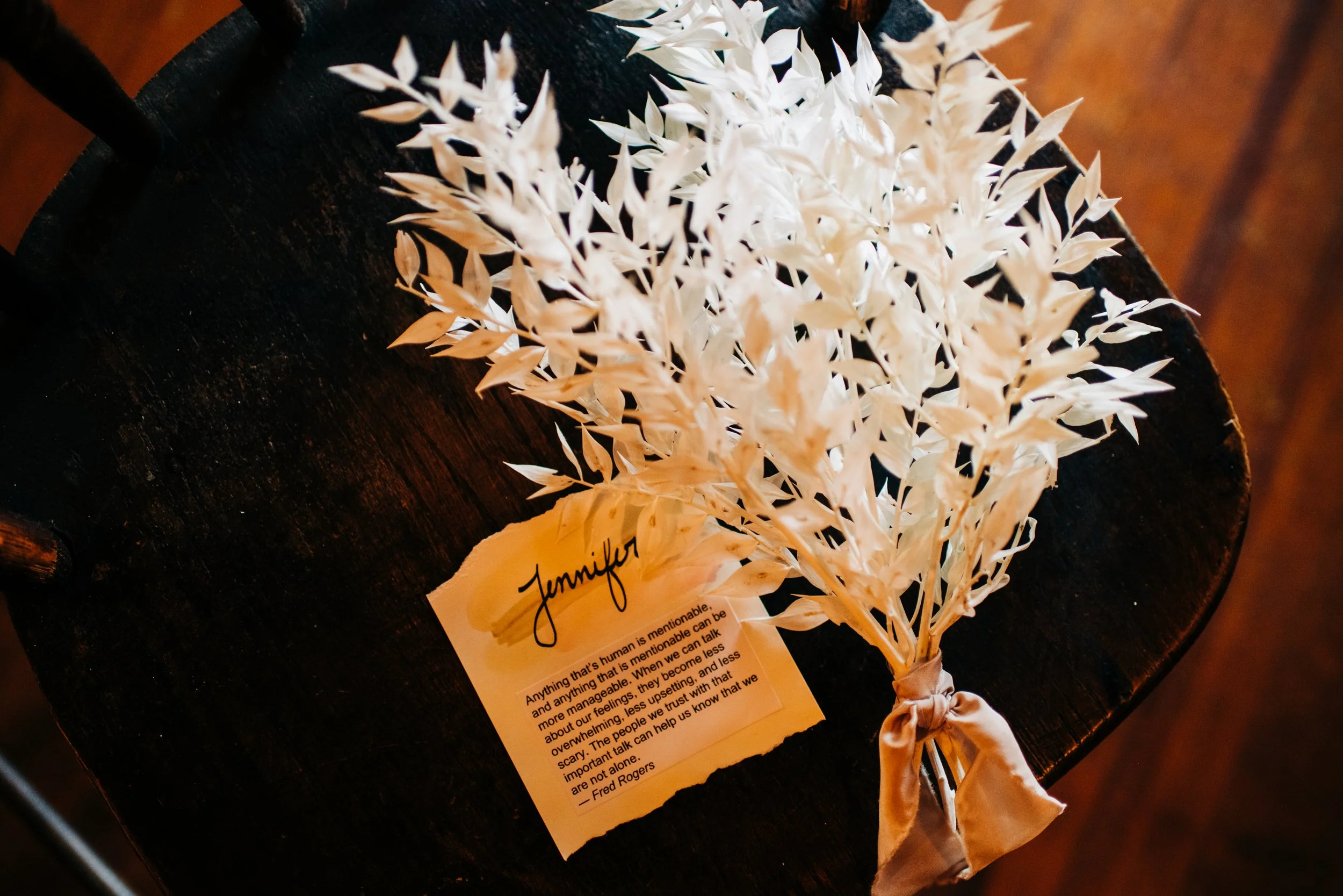 white dried leaves tied with a satin ribbon