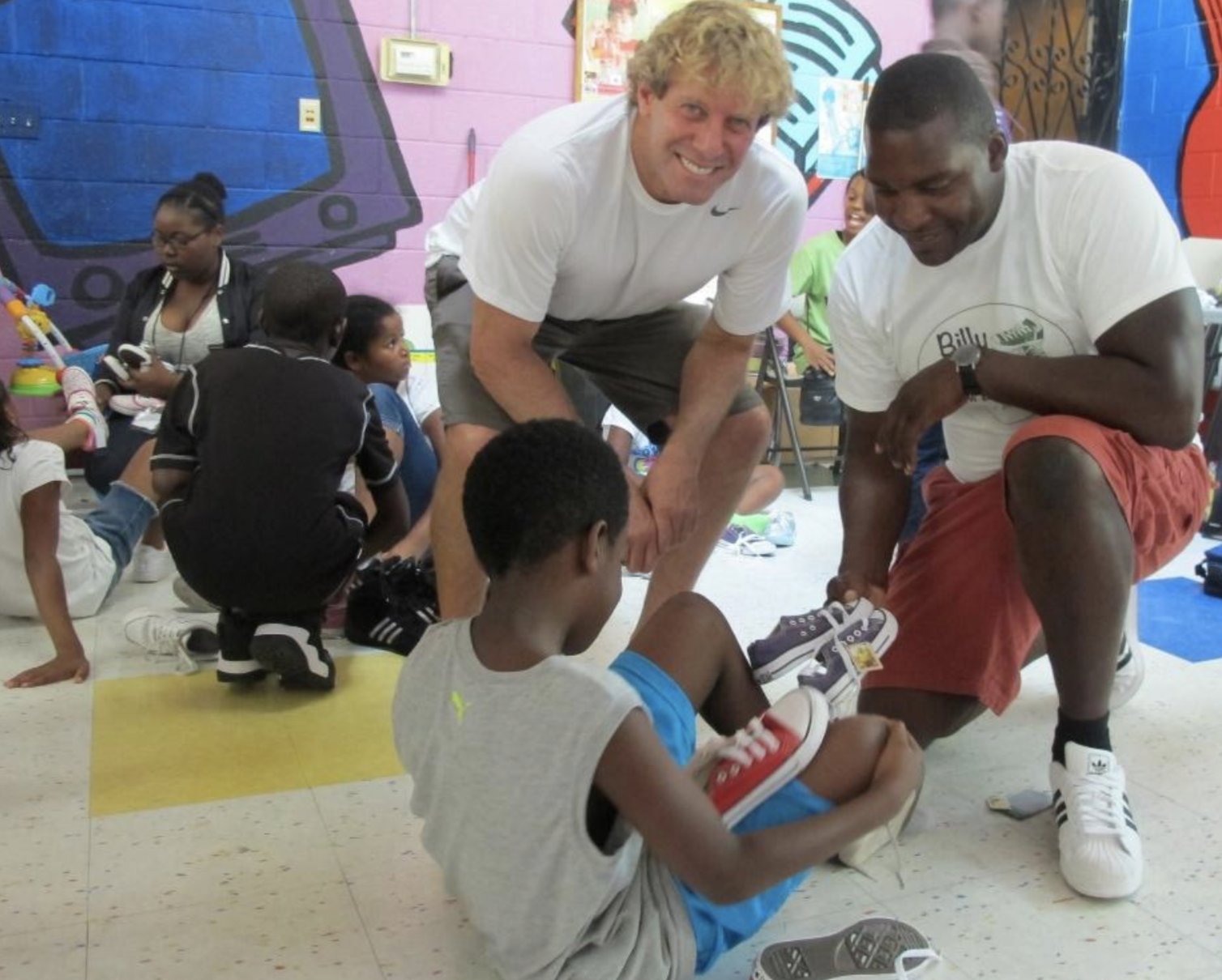 iPark CEO, Billy Lerner and Billy4kids, Alexson Roy helping fit children’s shoes.