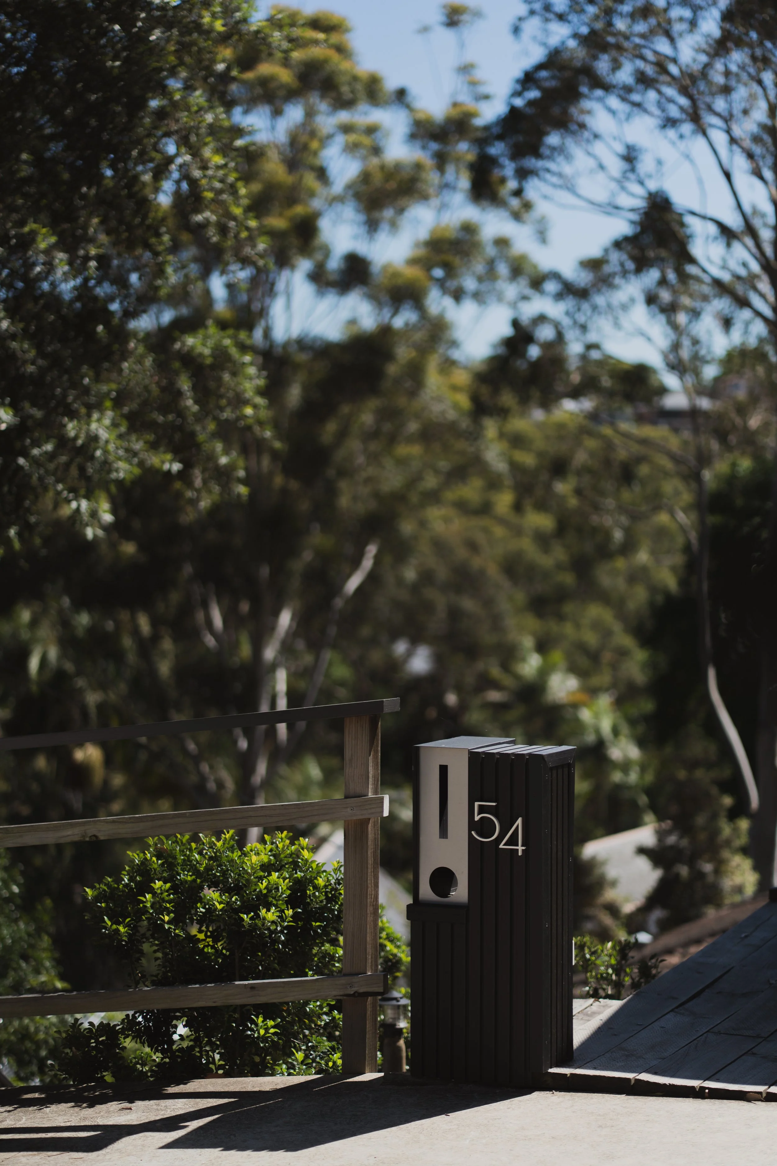 A custom-made composite decking post box designed to match modern outdoor spaces