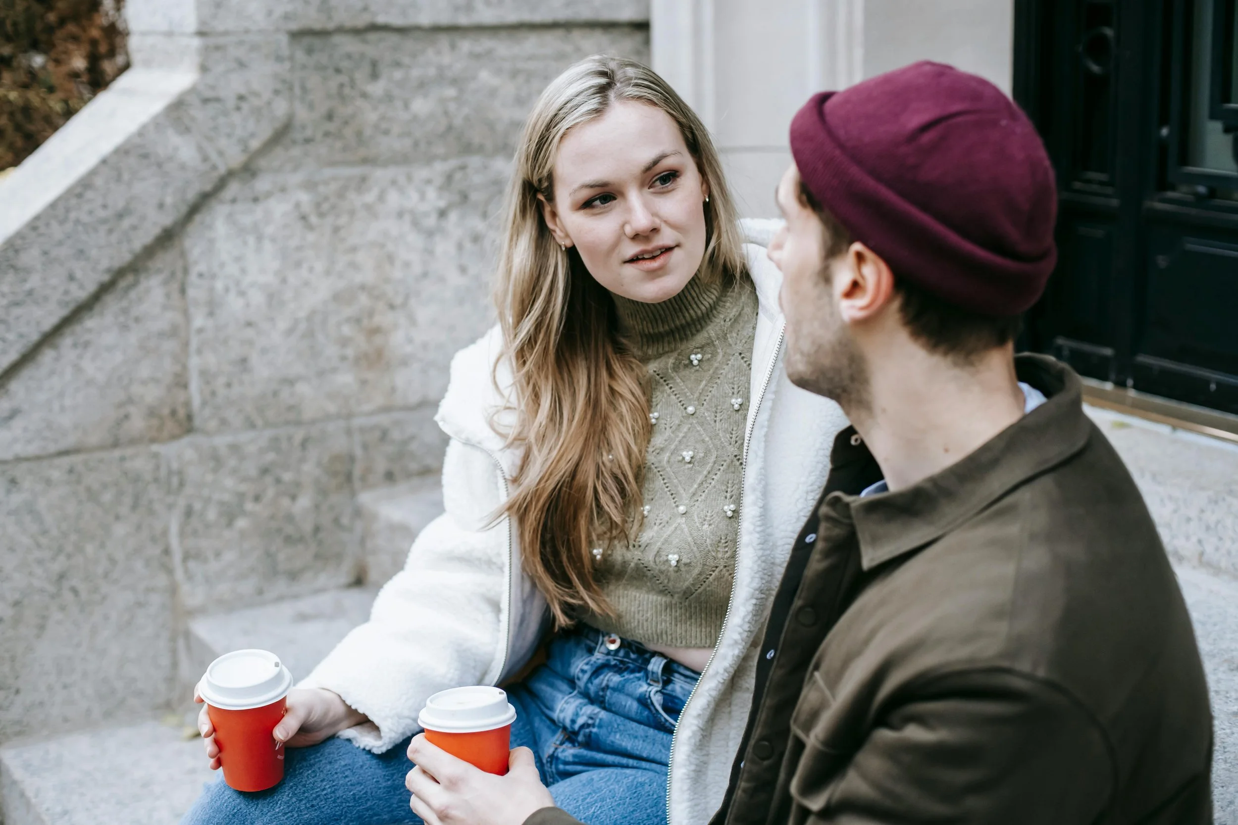 Young couple in Kalamazoo, MI having a conversation over coffee