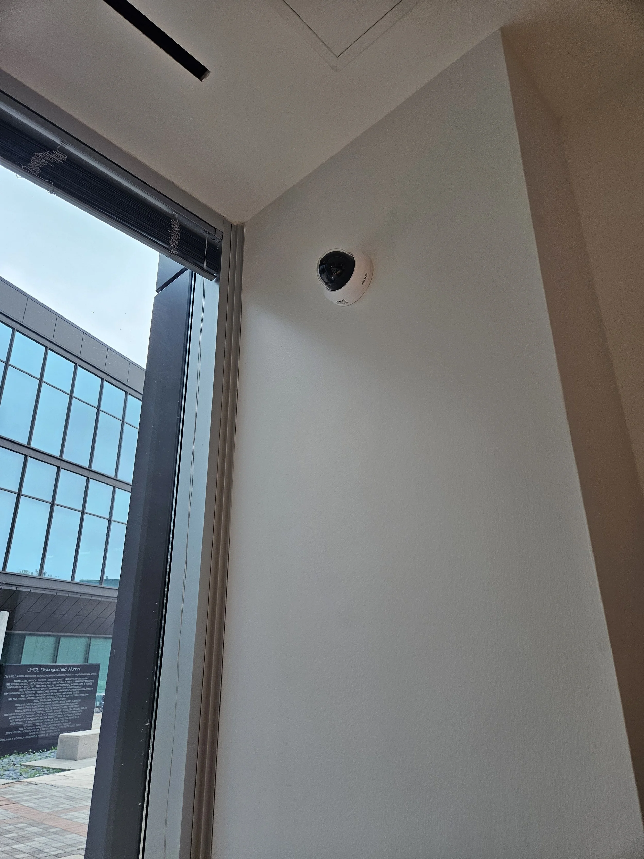 Commercial interior security camera installation positioned for discreet, effective coverage of entry and common areas.