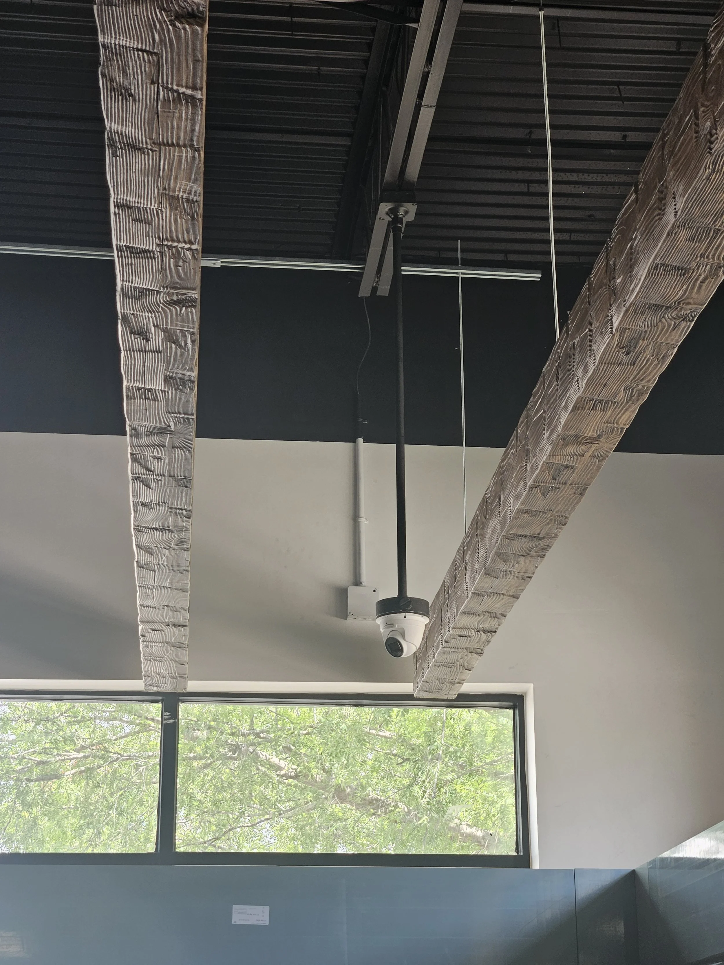 Custom drop-down camera installation designed to provide optimal coverage while maintaining a clean, professional appearance.