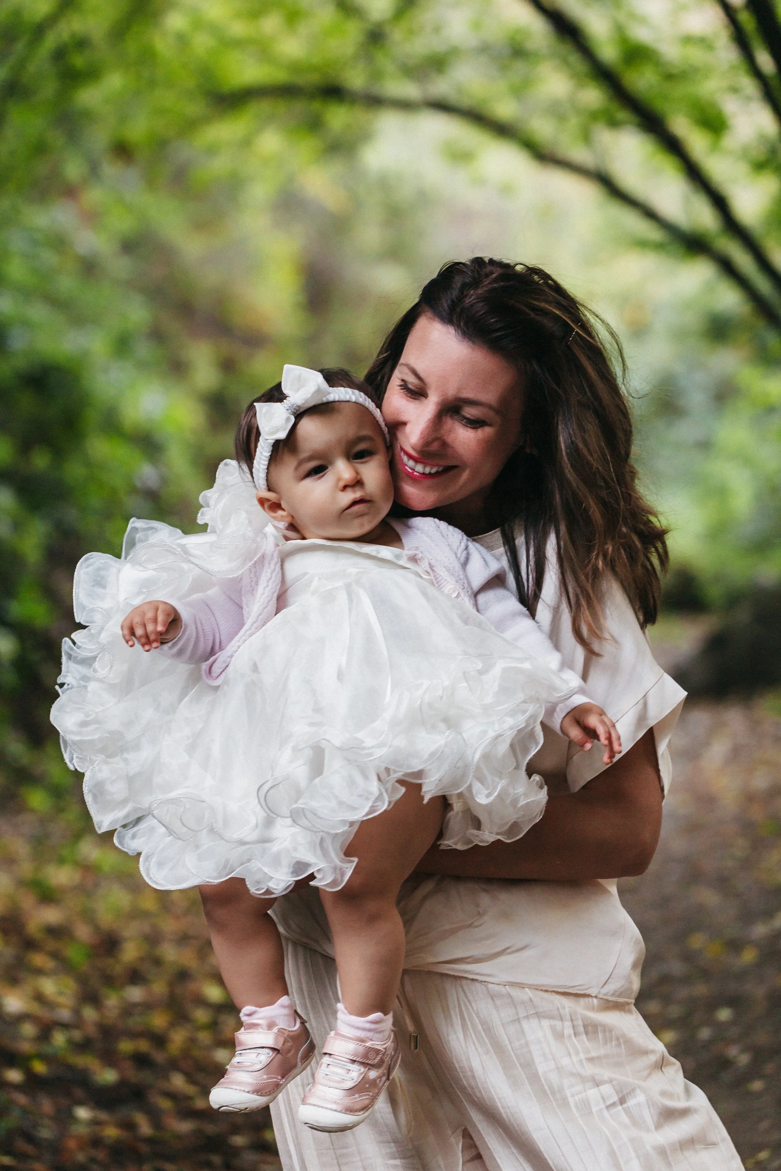 Gabie holding her one year old baby in her arms, expressing happiness and love