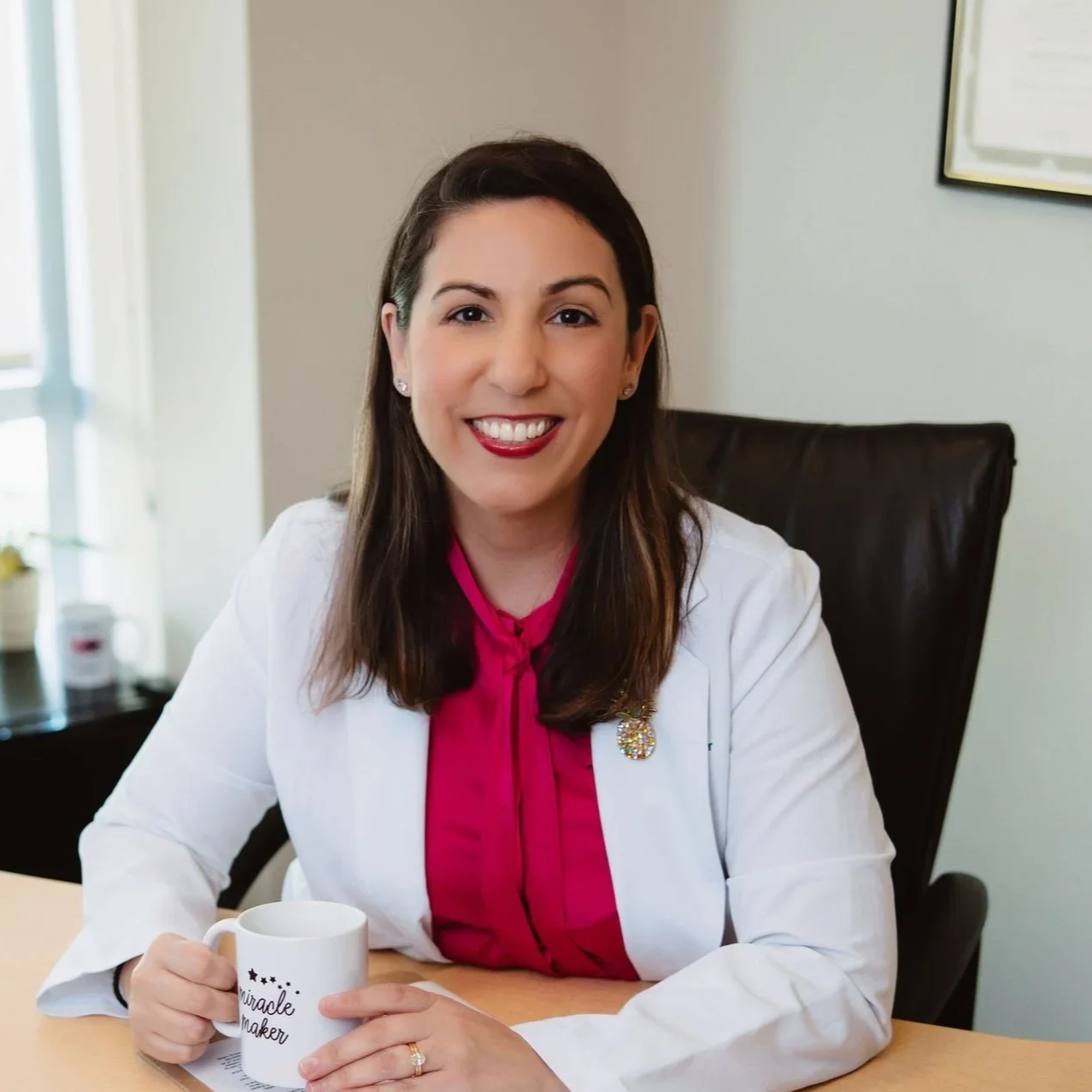 Dr Carolina Sueldo, IVF specialist sitting in her office