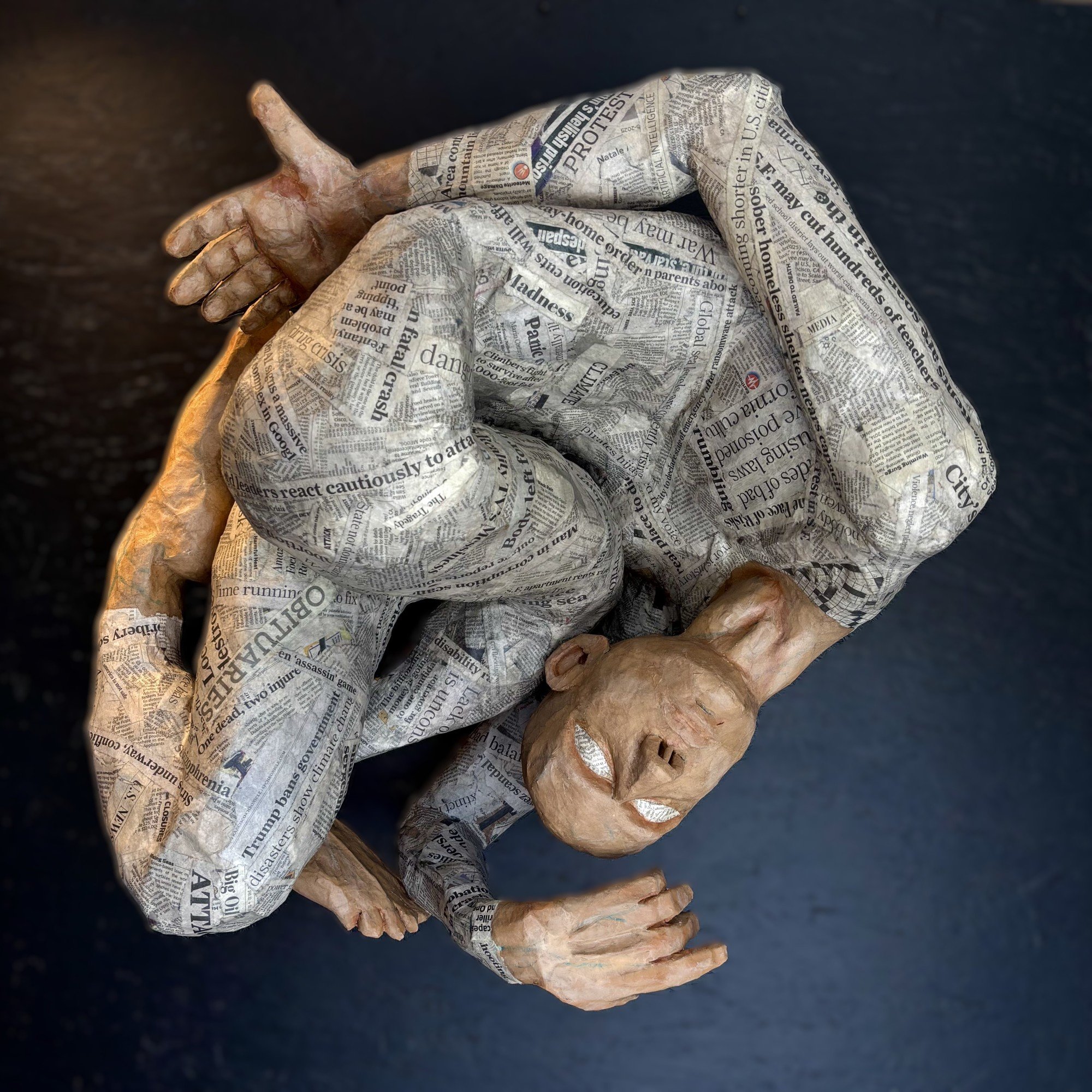 OVERCONSUMPTION LED TO THE BOTTOM life-sized paper mâché and acrylic
