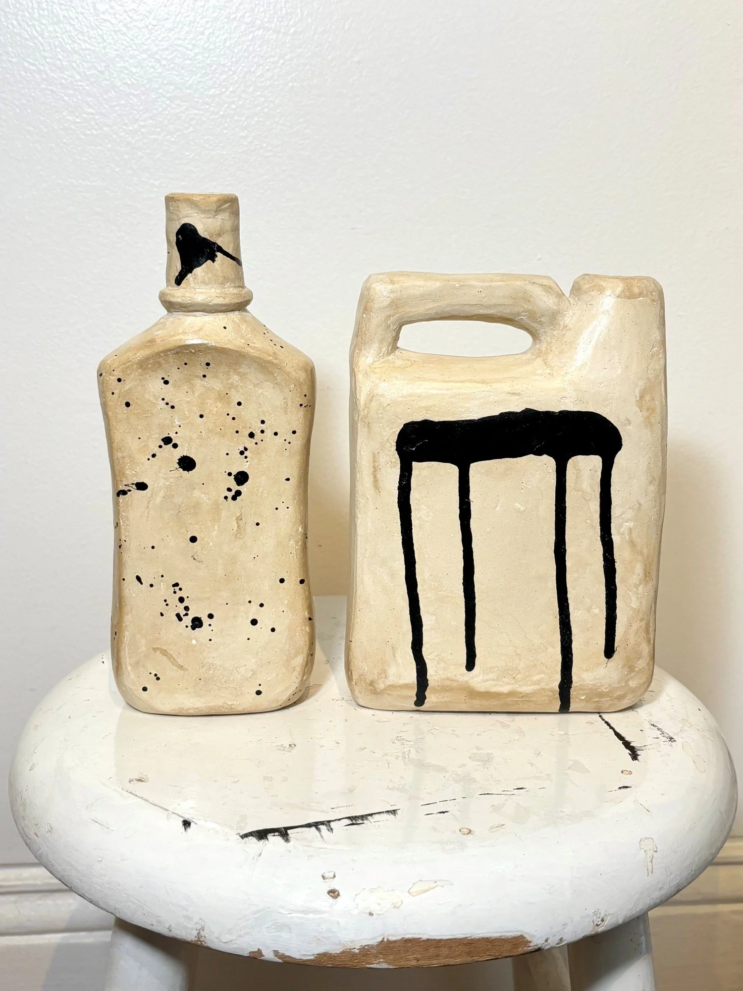 TRASH TO TREASURE VESSELS spotted: 9h x 3.5w x 2d in. with handle: 8h x 5w x 2d in. upcycled plastic mouthwash and soap bottle, paper mâché, ink and wax
