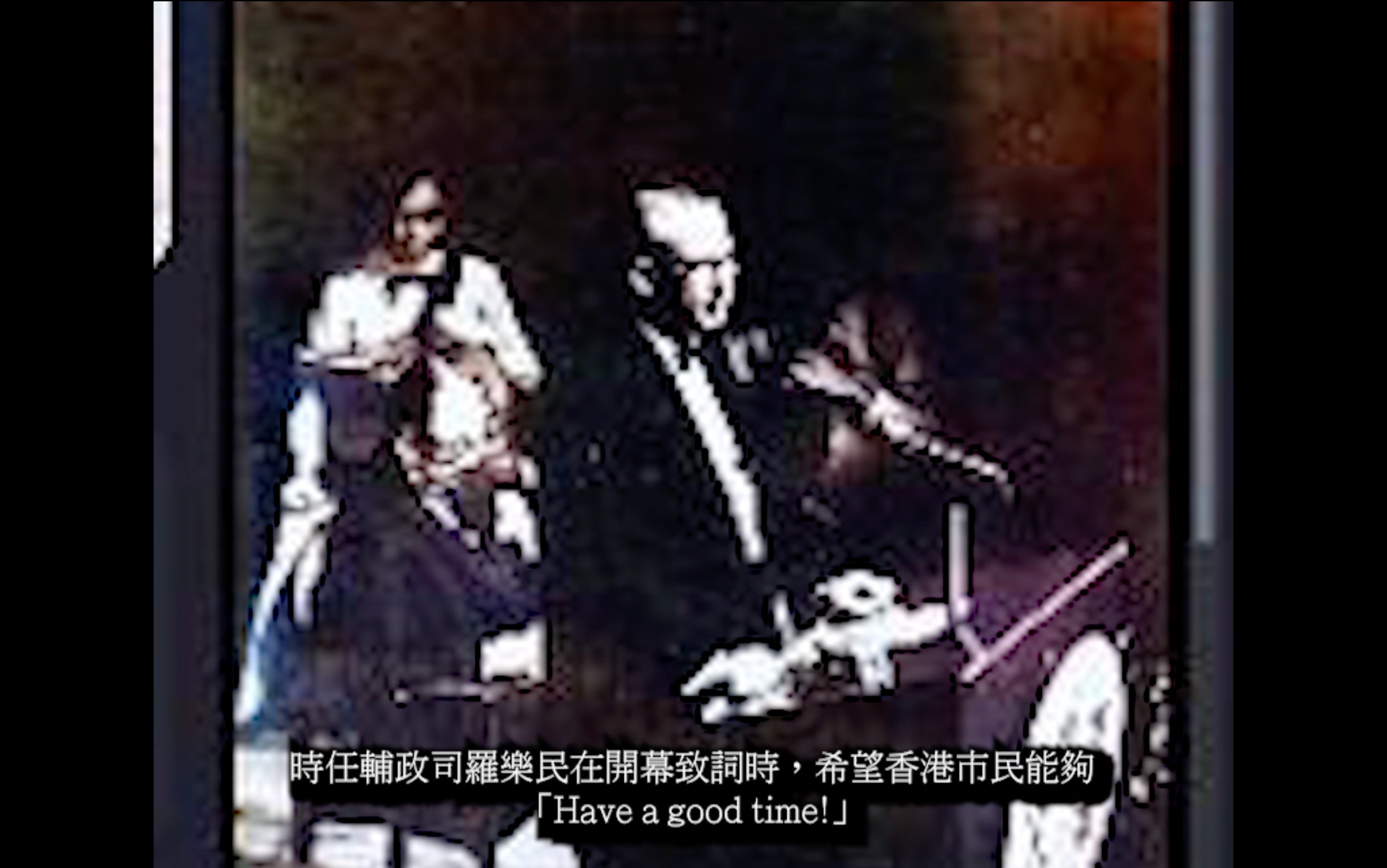 Two men, one in a wheelchair, are standing outside near a railing with a person taking a photo. The man in the wheelchair is wearing glasses and a jacket, smiling. The other man is wearing a sweater and has a beard. There is a subtitle that reads, "Have a good time!" in both Chinese and English.