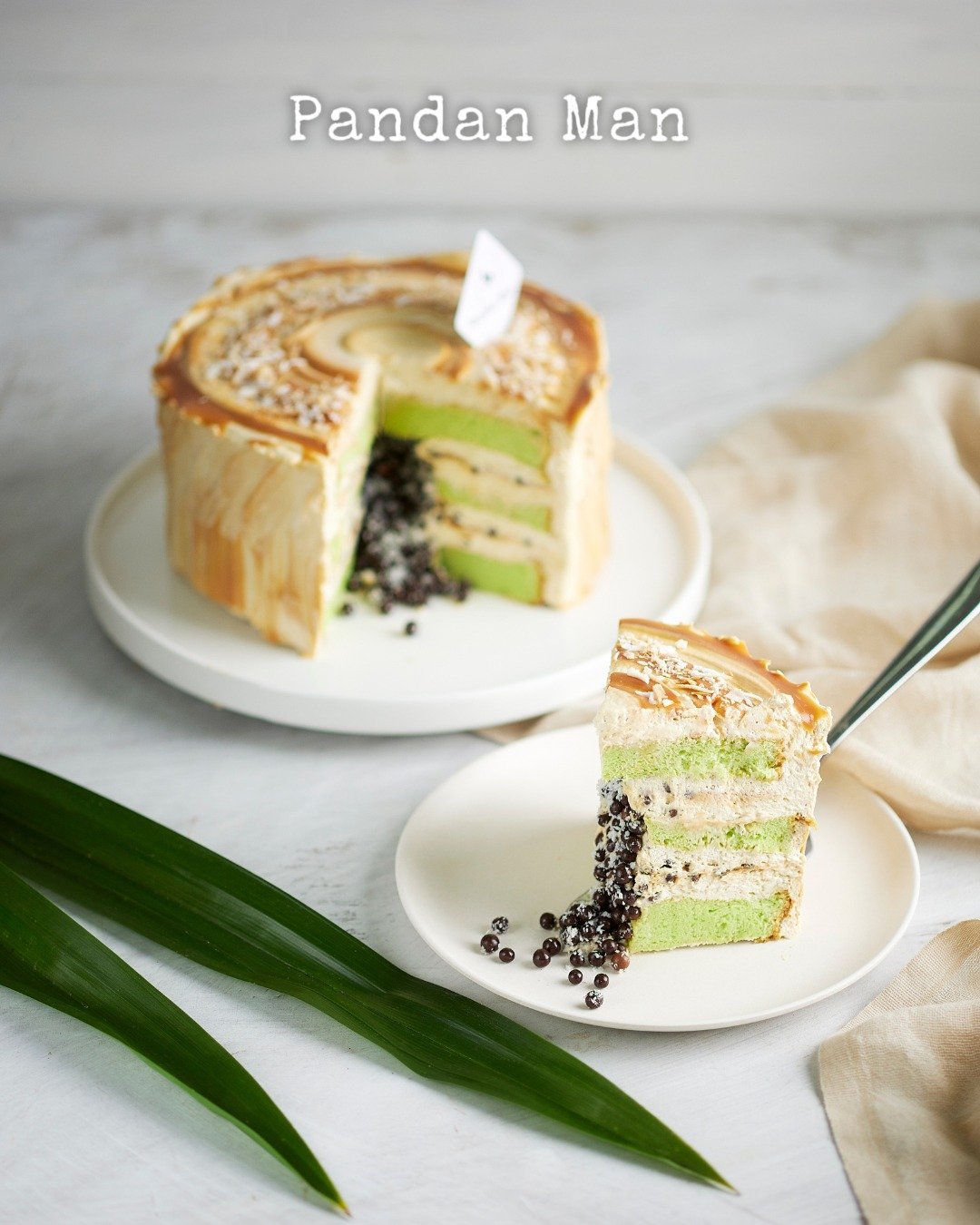 Sweet, salty, and everything in between &mdash; our Salted Caramel with Toasted Coconut Pandan Cake is a flavor celebration in every bite. Moist pandan chiffon layers meet rich salted caramel, crunchy chocolate, and a crown of perfectly toasted cocon