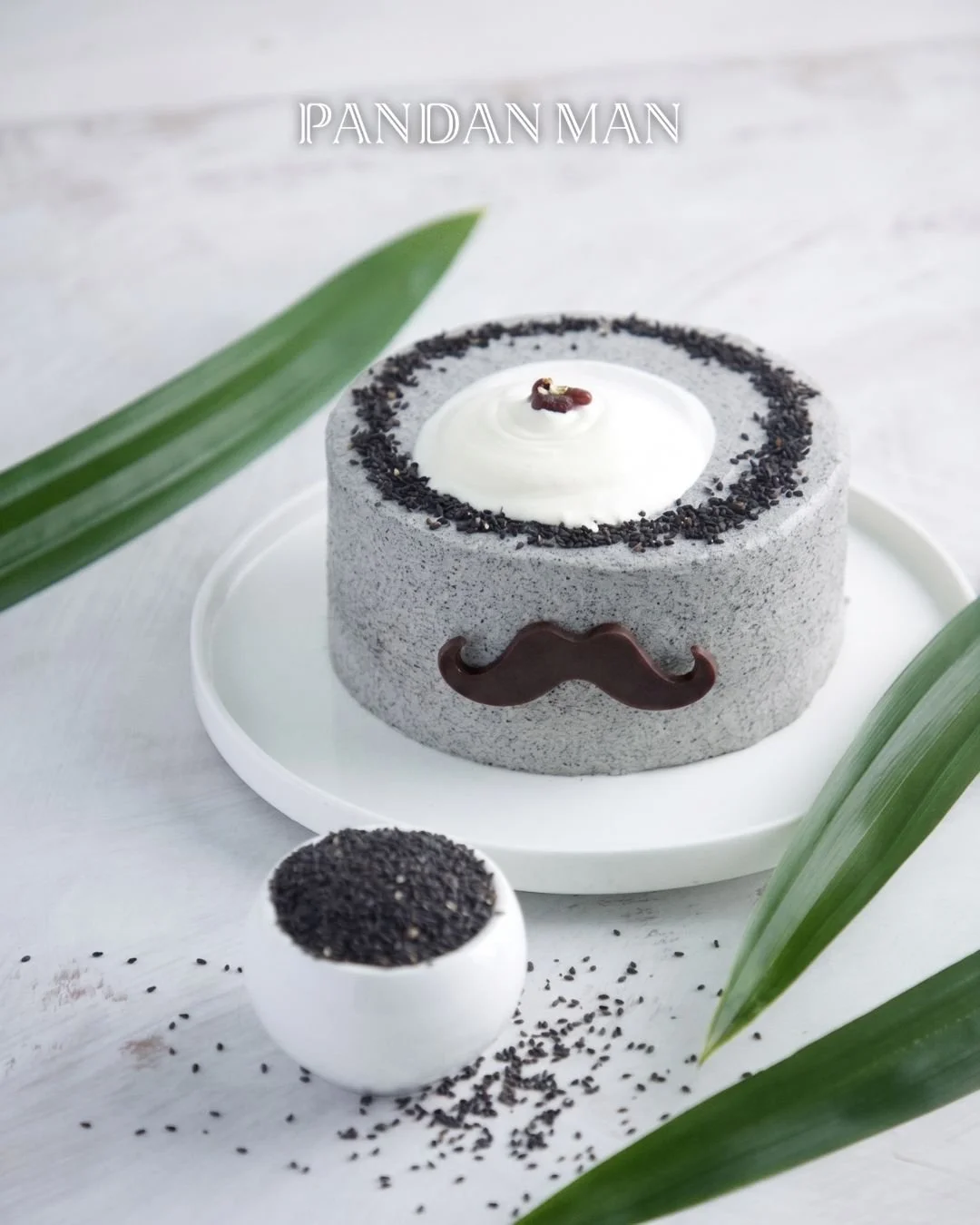 Not every cake needs to be serious. 🤪

The Black Sesame Pandan Cake uses house-made, rich, nutty, and earthy black sesame paste, finished with a moustache detail that says "Father's Day" without trying too hard. It's simple, warm, and just