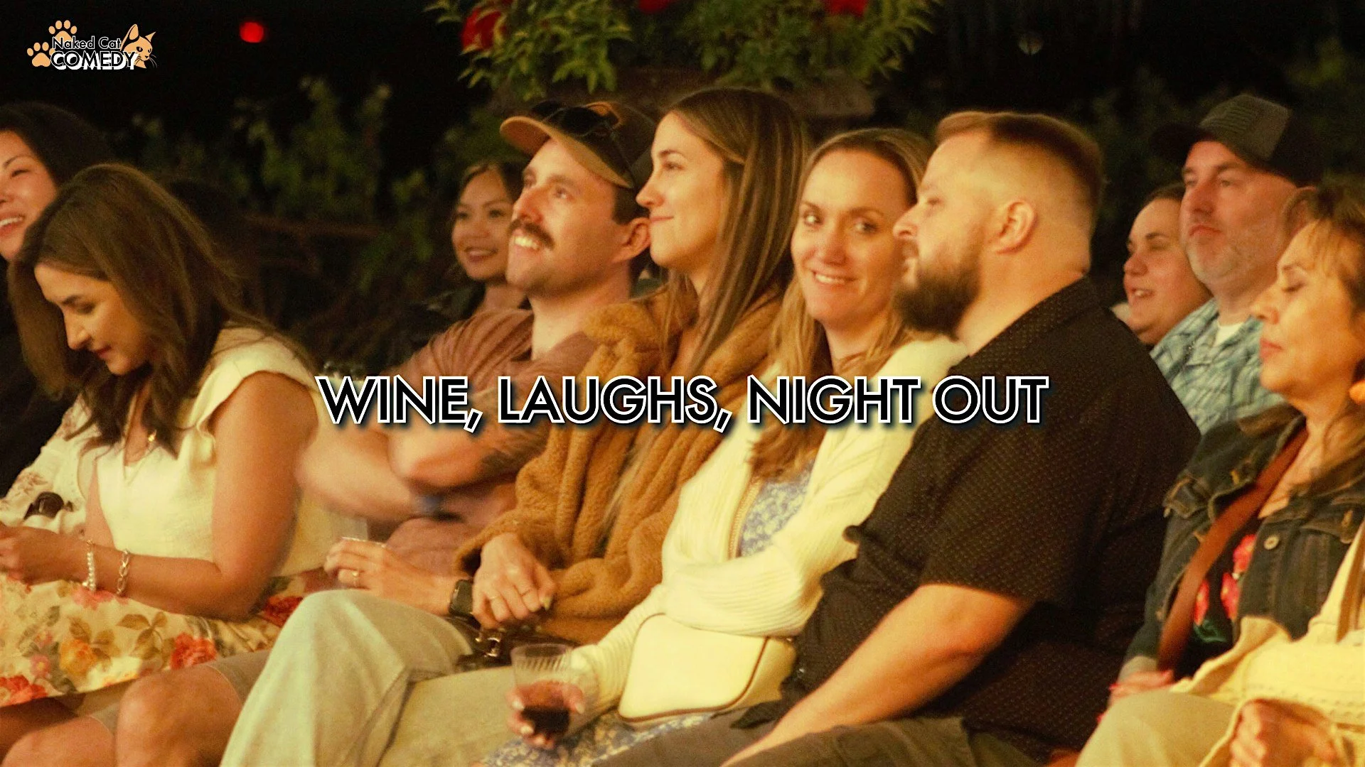 Group of people sitting and enjoying a night out, with the text "WINE, LAUGHS, NIGHT OUT" overlaid.
