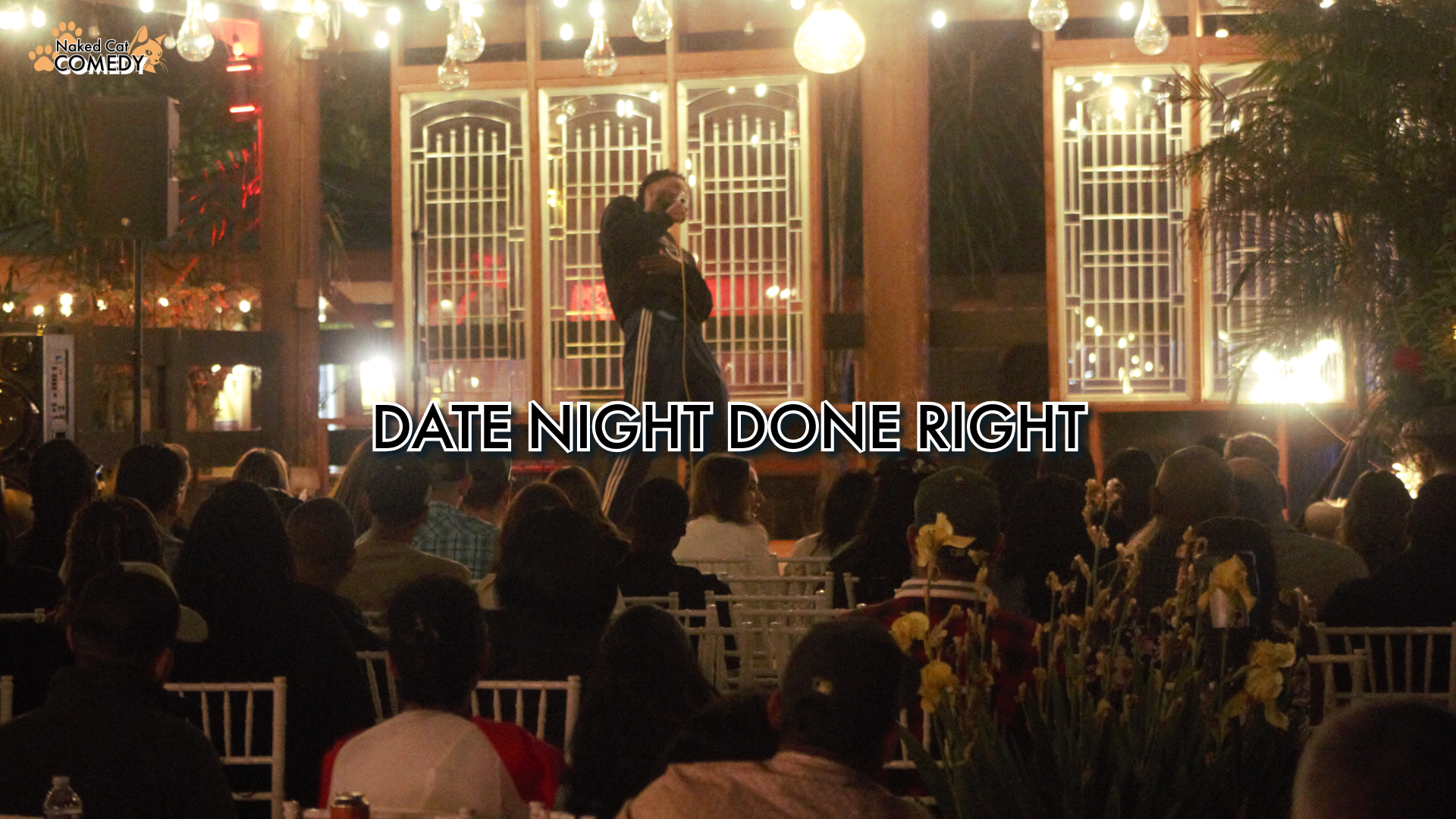 A comedy show on stage with a comedian performing in front of an audience at night, decorated with hanging lights and plants, with the text 'Date Night Done Right' overlaid.