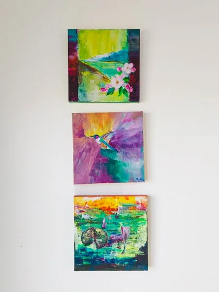 Three paintings by artist Torunn Urnes Meyer hanging on a wall