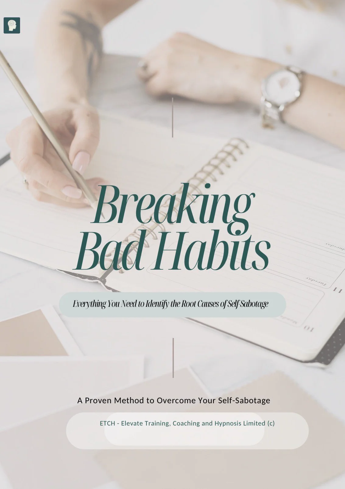 Book titled 'Breaking Bad Habits' on a desk with notes and a person's hand holding a pen, person wearing a silver watch.