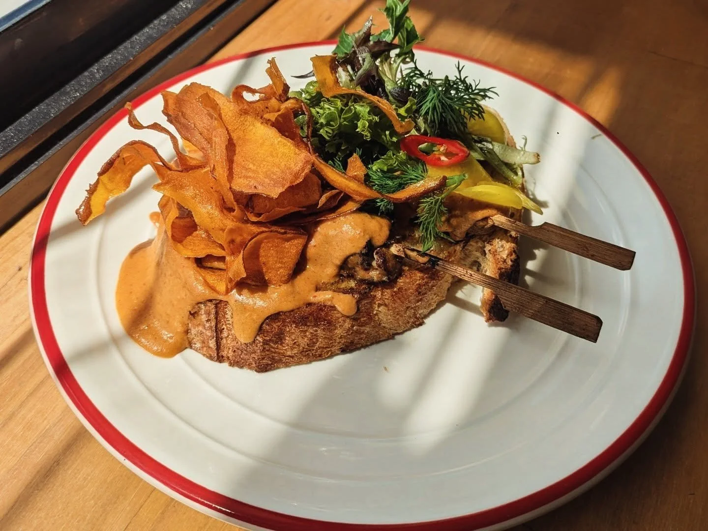 Check this out

Grilled satay chicken  toast 
Grilled chicken with homemade satay sauce, sourdough, garlic dressed mixed leaves, daikon pickle and sweet potato crisps 
#theparcel #HobartCoffee #hobartbrunch