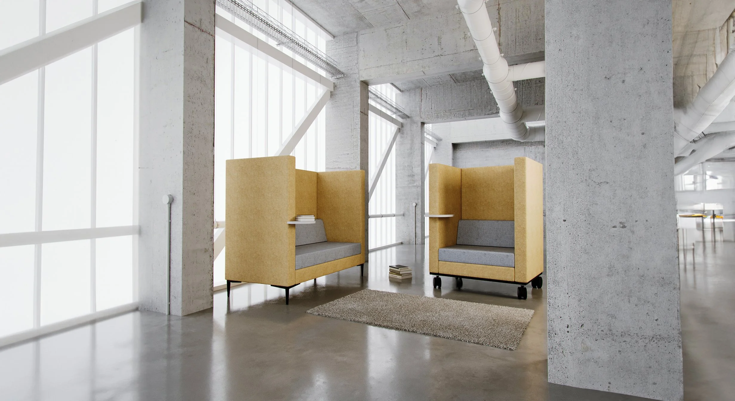 Modern office lounge with two beige and gray upholstered high-backed chairs, small side tables, a stack of books, and a beige rug on a shiny concrete floor, set against large windows with white blinds and exposed concrete walls and ceiling pipes.