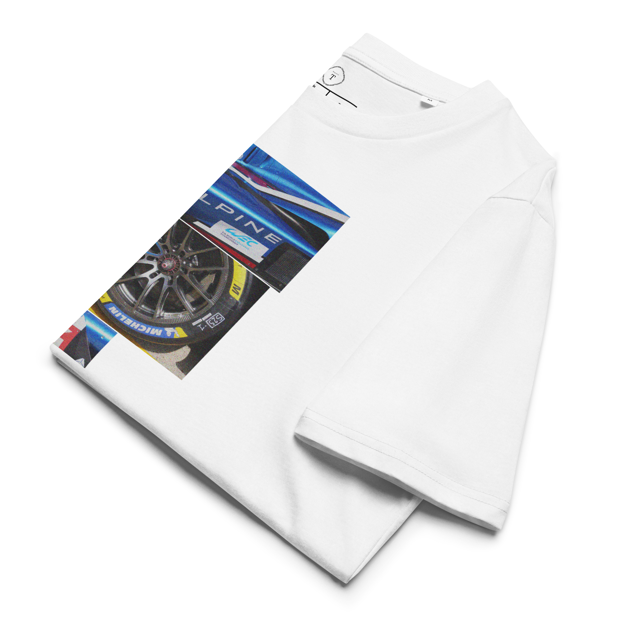 White Unisex Cotton T-Shirt folded close up with sqaure box design with photographs of Alpine from multiple angles at Le Mans