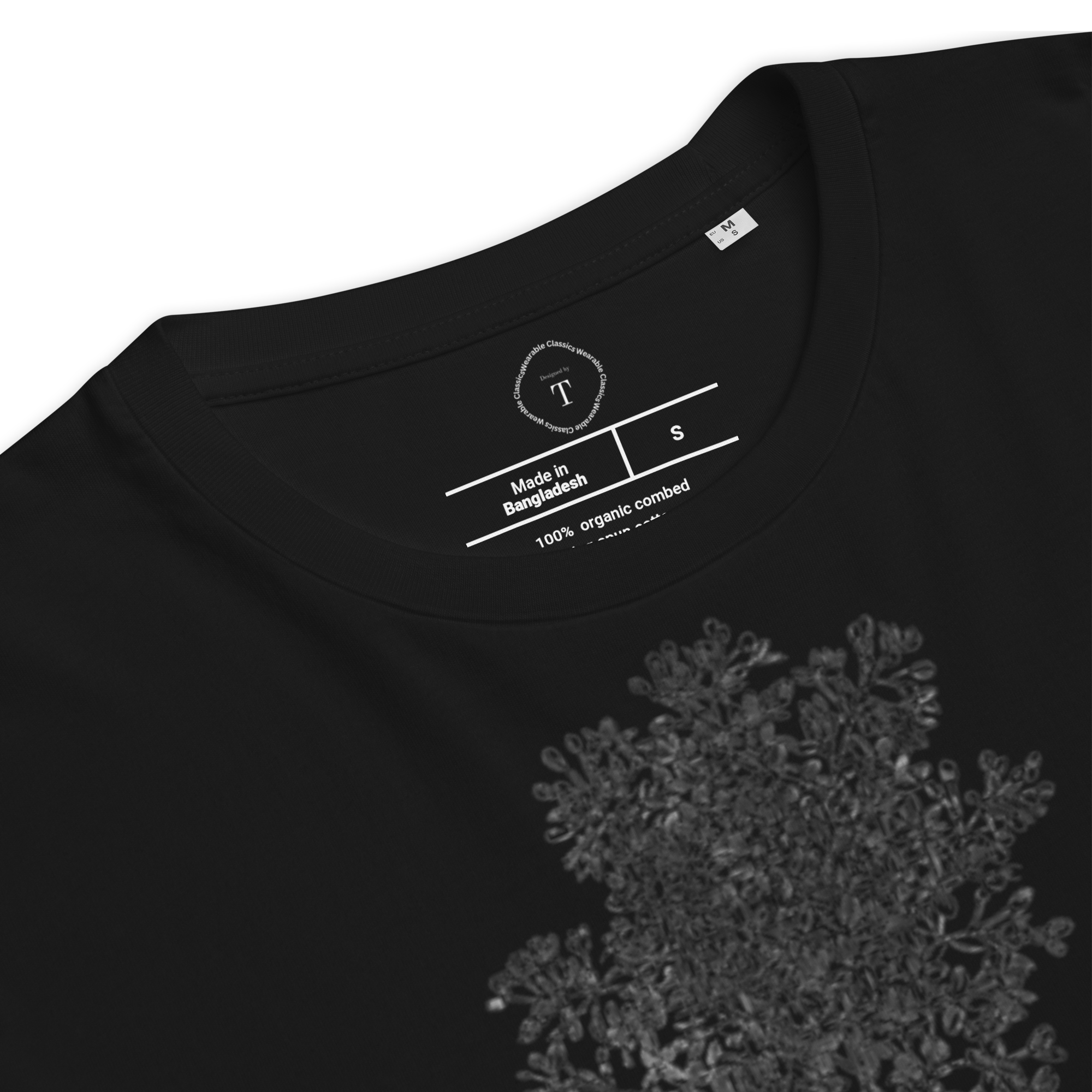 Black Unisex Cotton T-Shirt folded close up with black and white image of wildflower in the centre