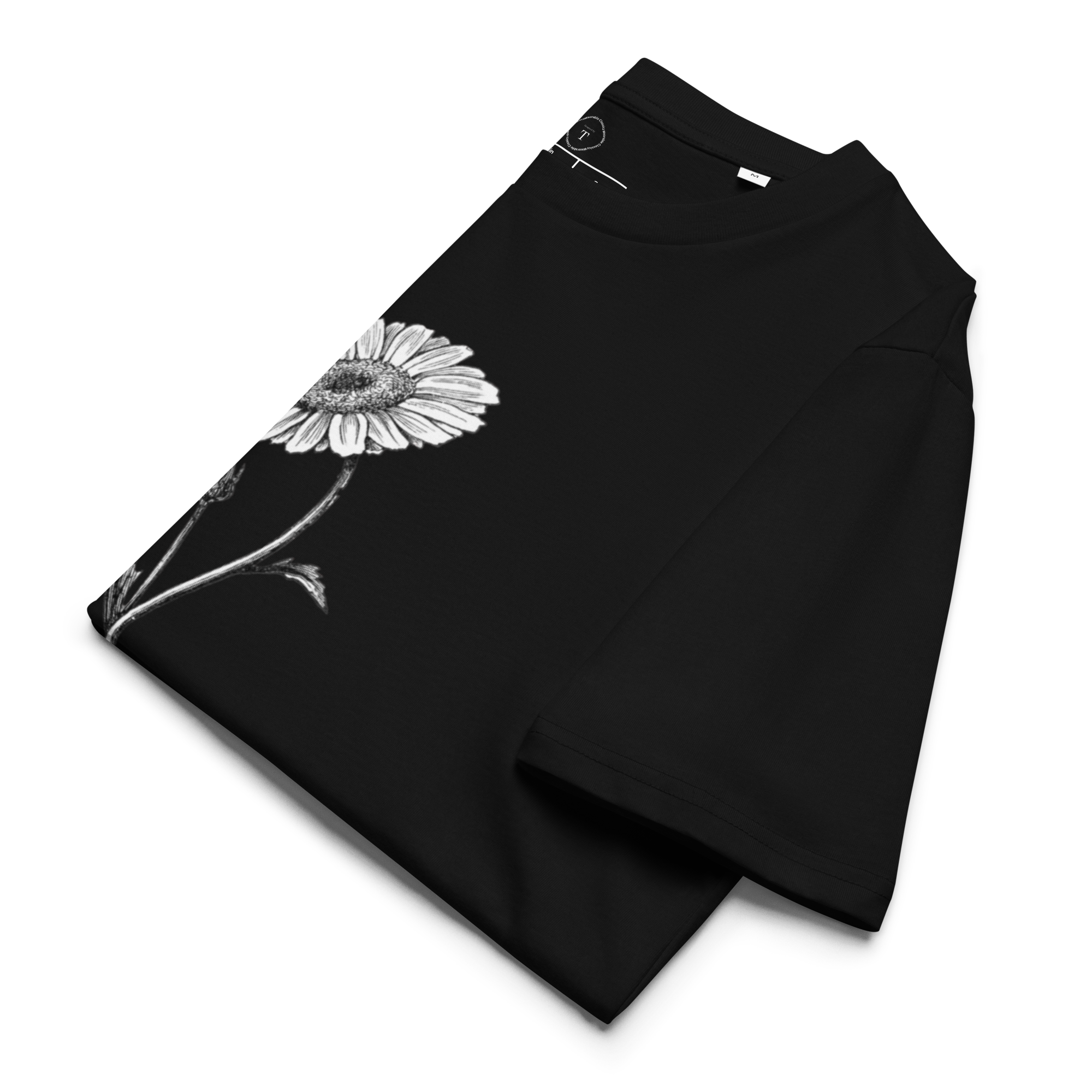 Black Unisex Cotton T-Shirt folded close up with black and white image of daisy flower in the centre