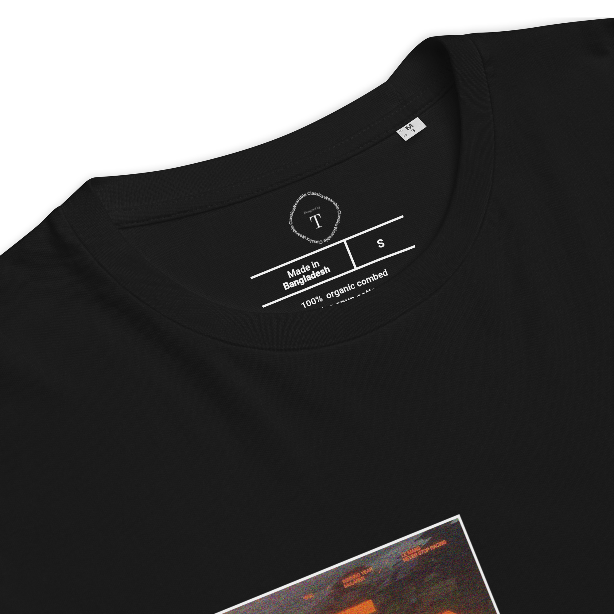 Black Unisex Cotton T-Shirt folded close up with sqaure box design with photographs of McLaren Racing from multiple angles at Le Mans