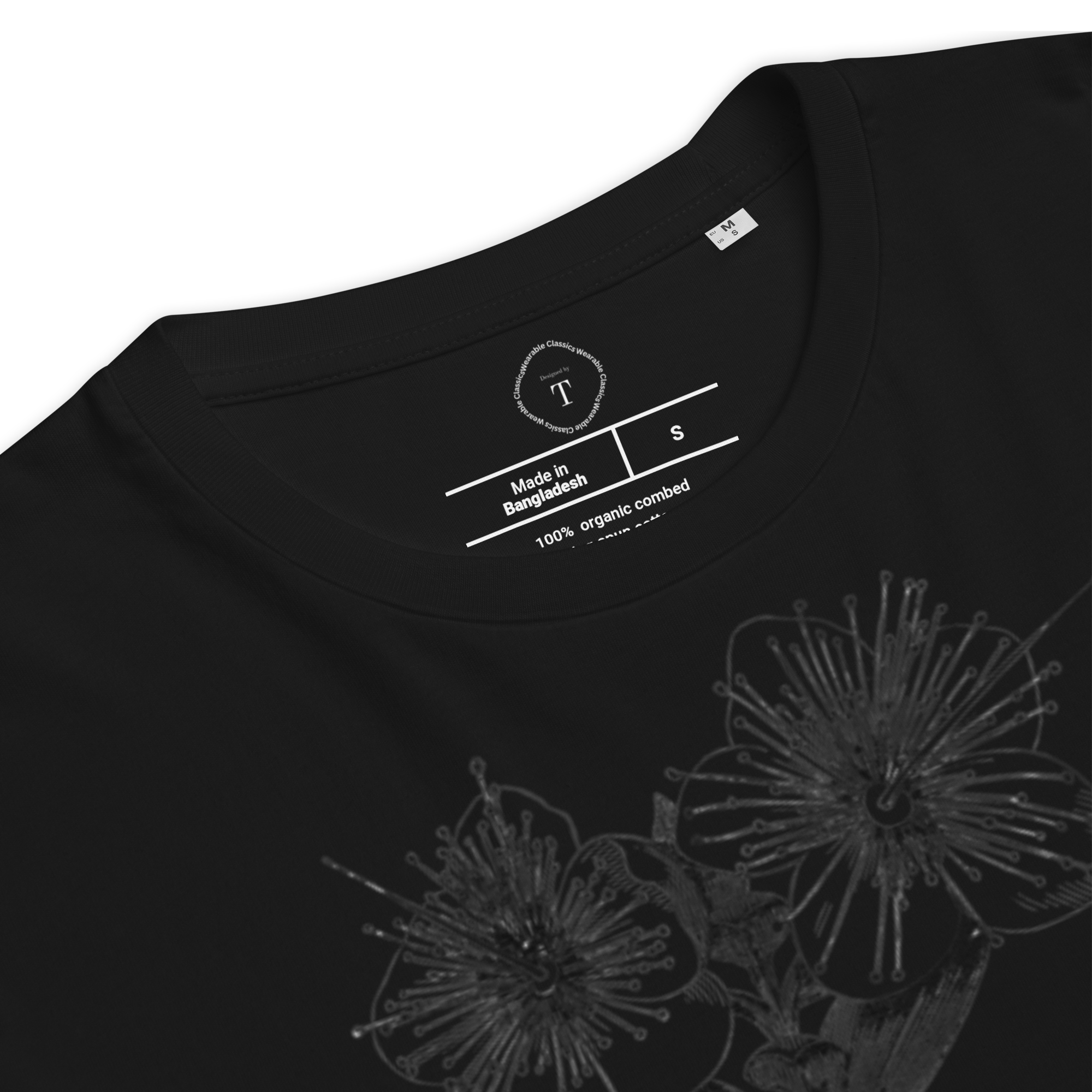 Black Unisex Cotton T-Shirt folded close up with black and white image of flower in the centre