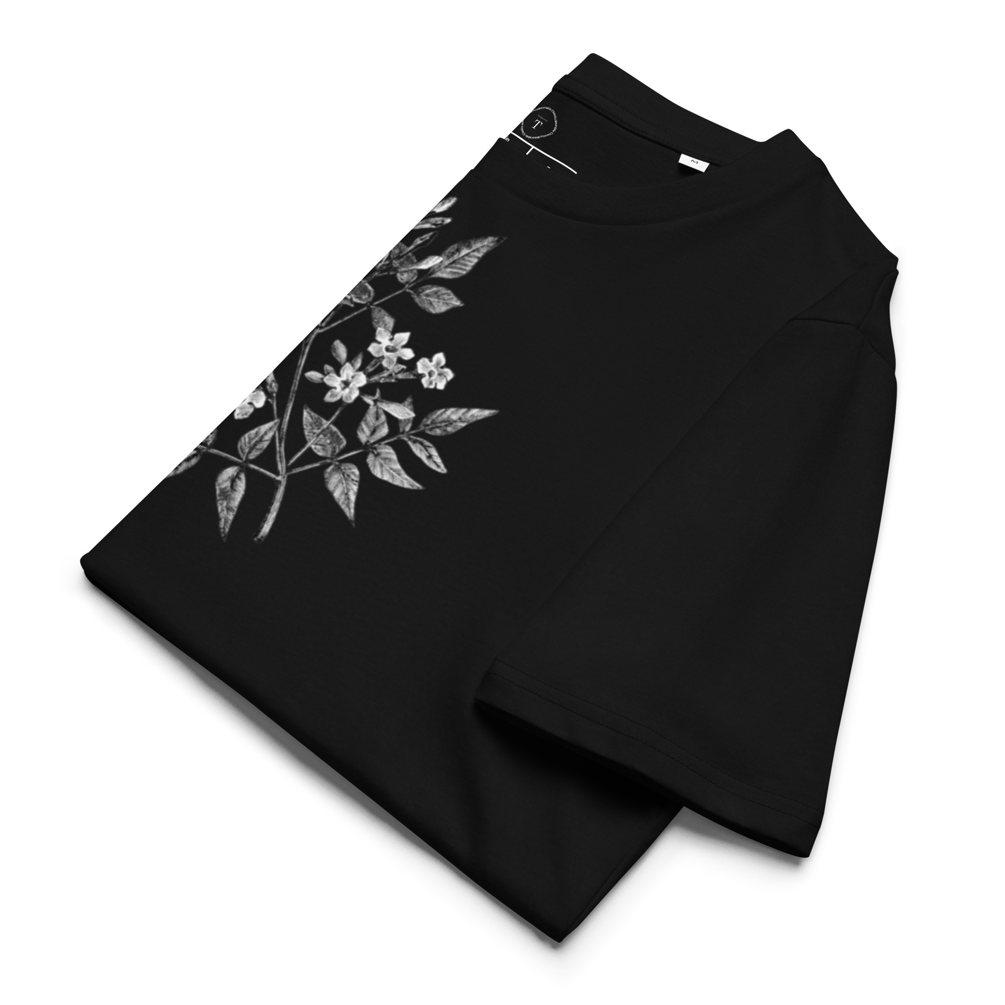 Black Unisex Cotton T-Shirt folded close up with black and white image of jasmine flower in the centre