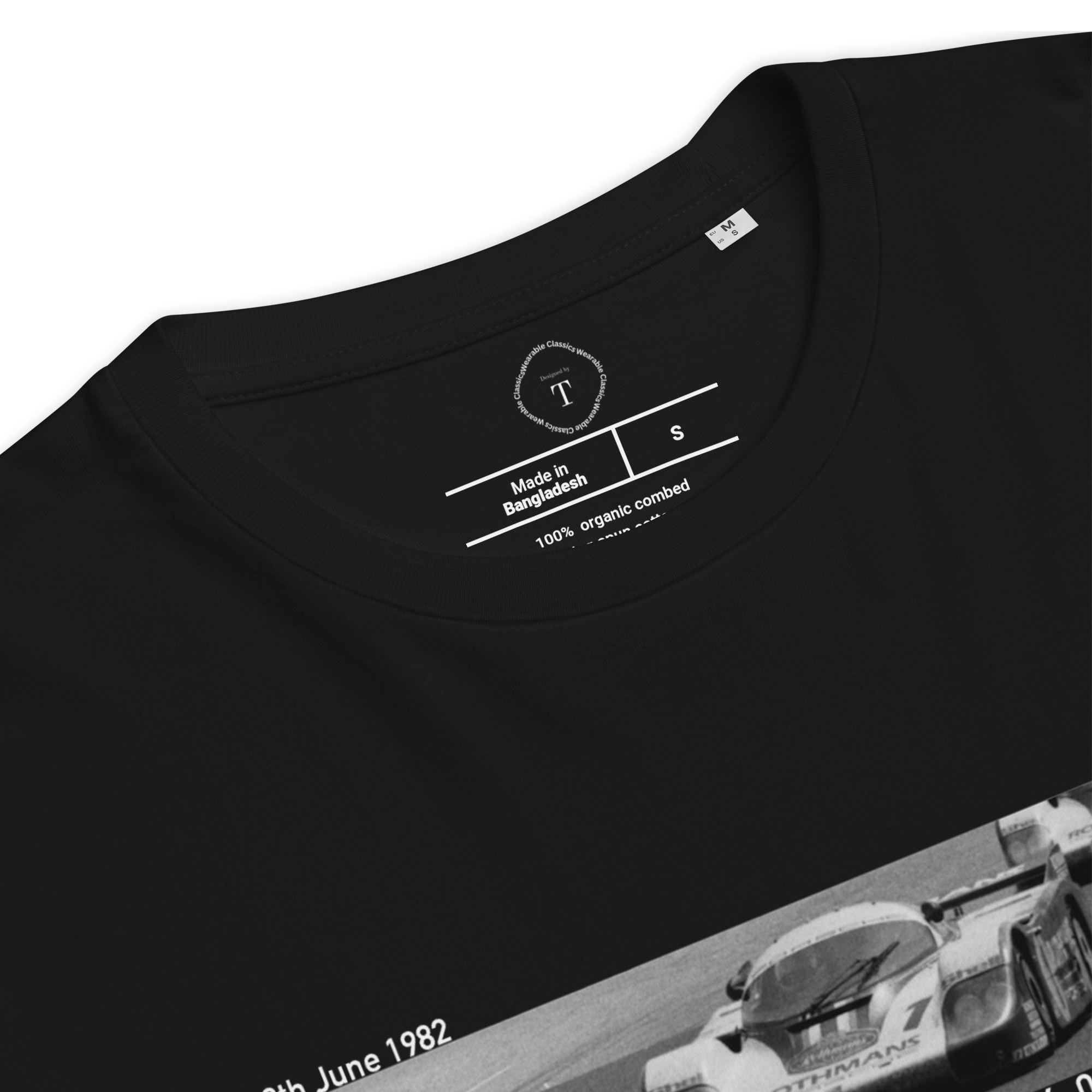 Black Unisex Cotton T-Shirt folded close up with banner image of Porsche 1982 at Le Mans in the centre with text of coordinates and date of race