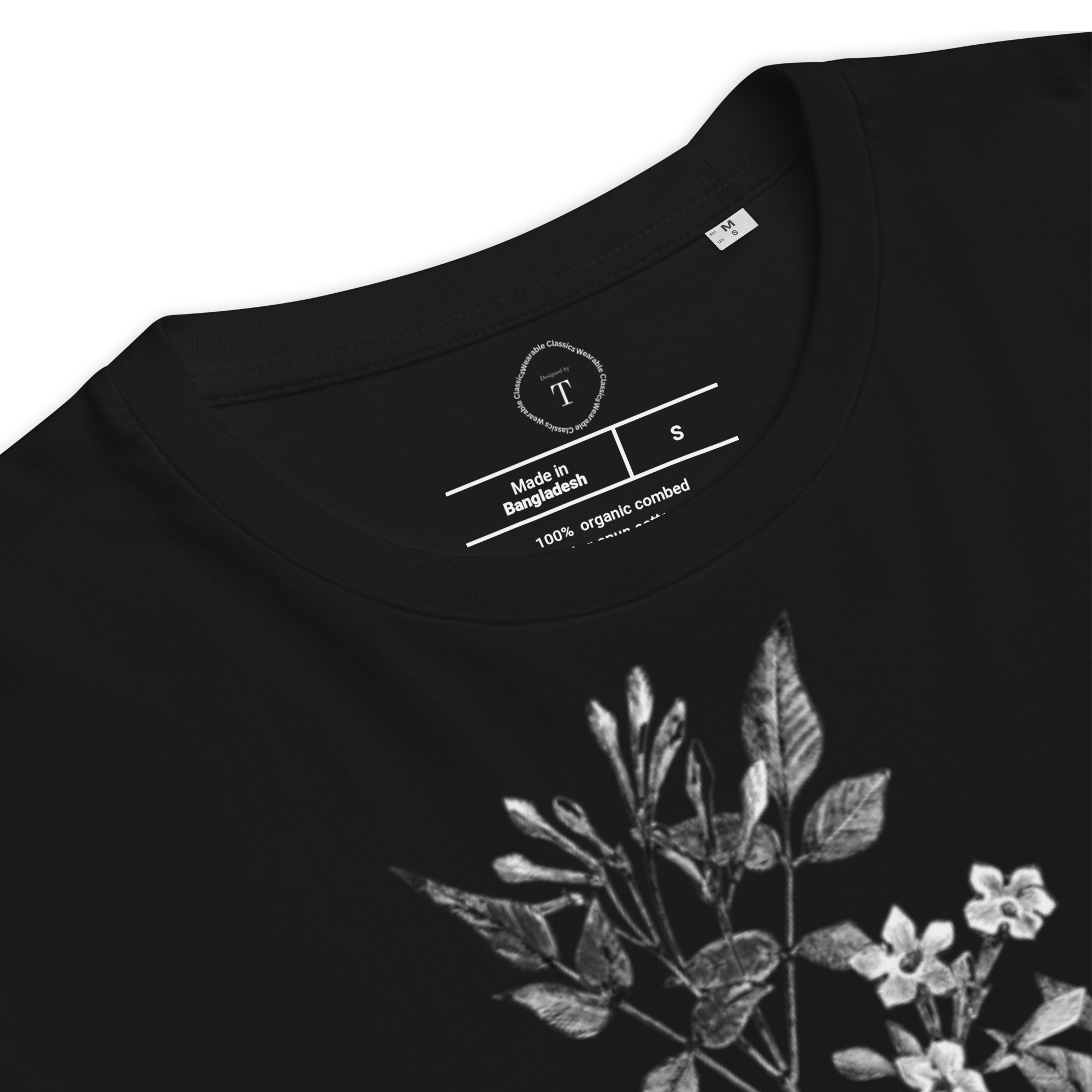 Black Unisex Cotton T-Shirt folded close up with black and white image of jasmine flower in the centre