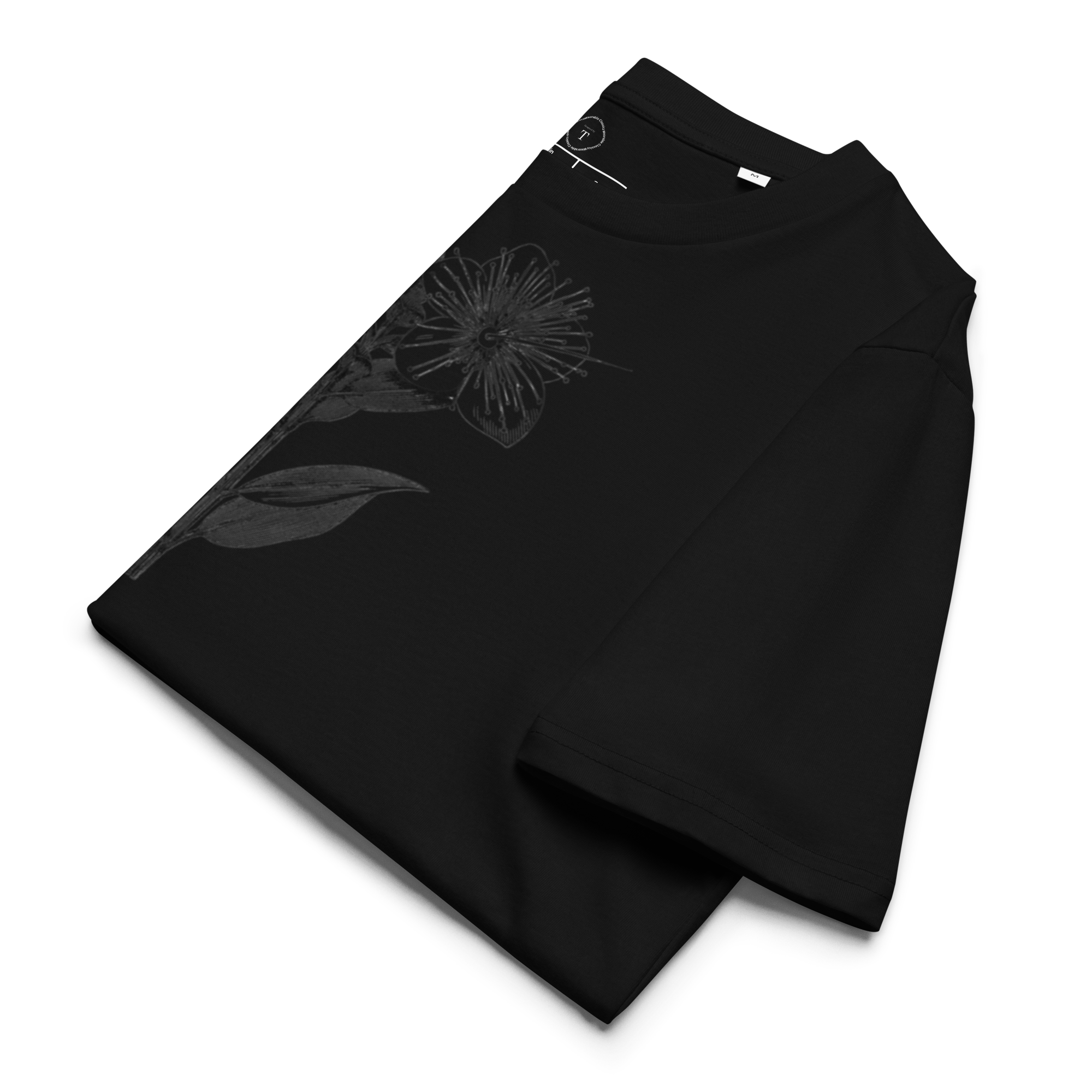 Black Unisex Cotton T-Shirt folded close up with black and white image of flower in the centre