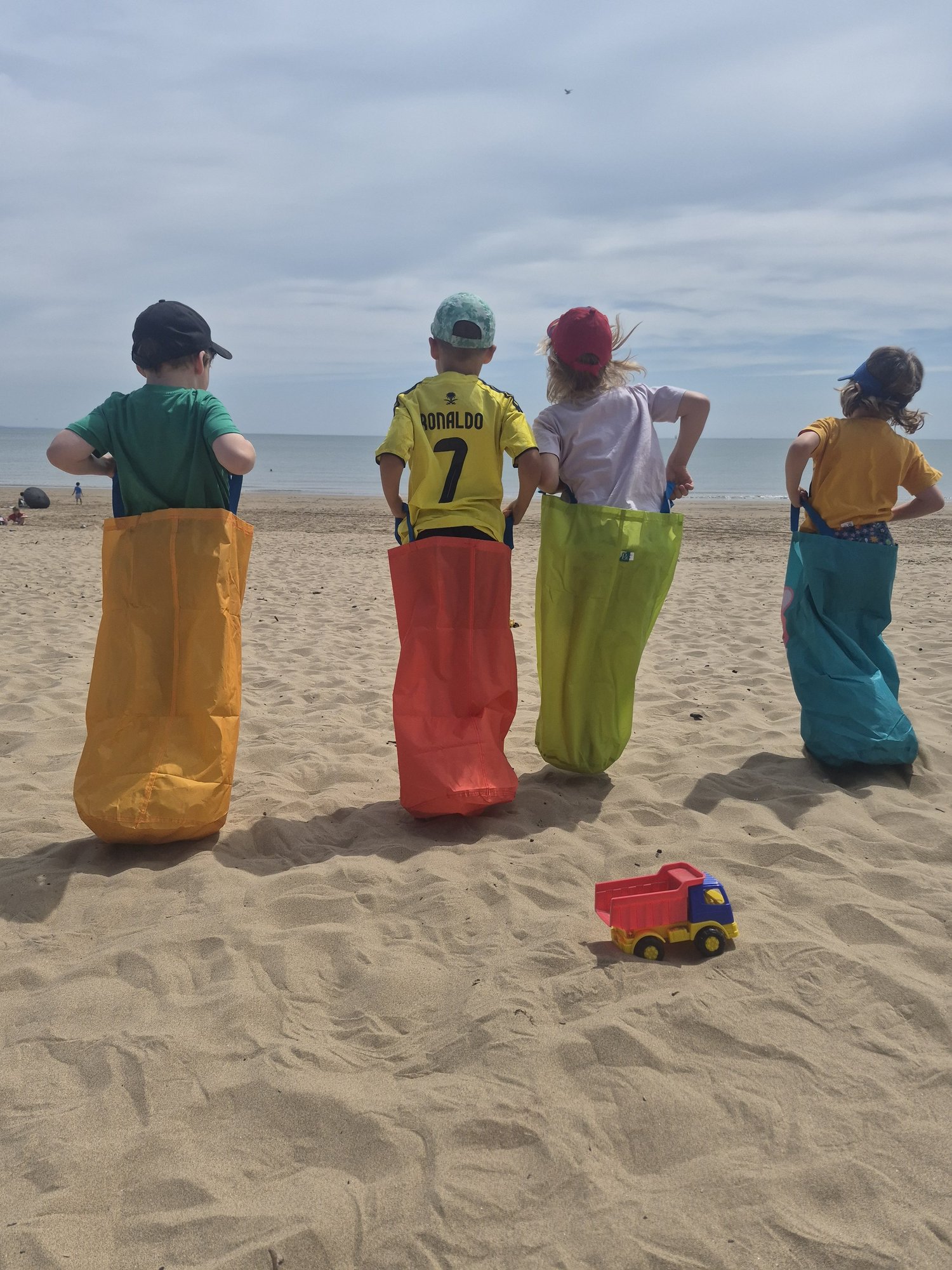 Children sack racing on the beach