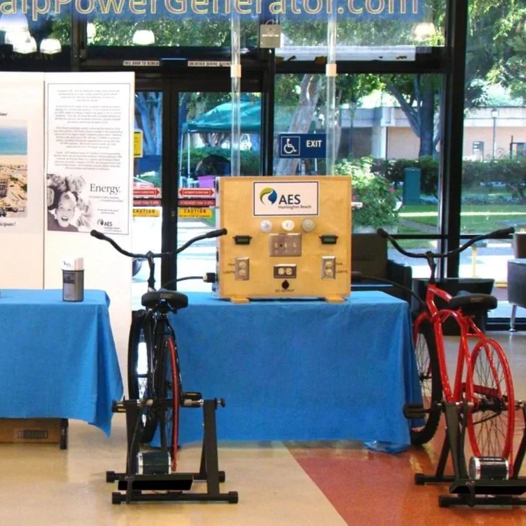 A DC motor with a black label, showing wiring and four mounting screws placed in front of it.