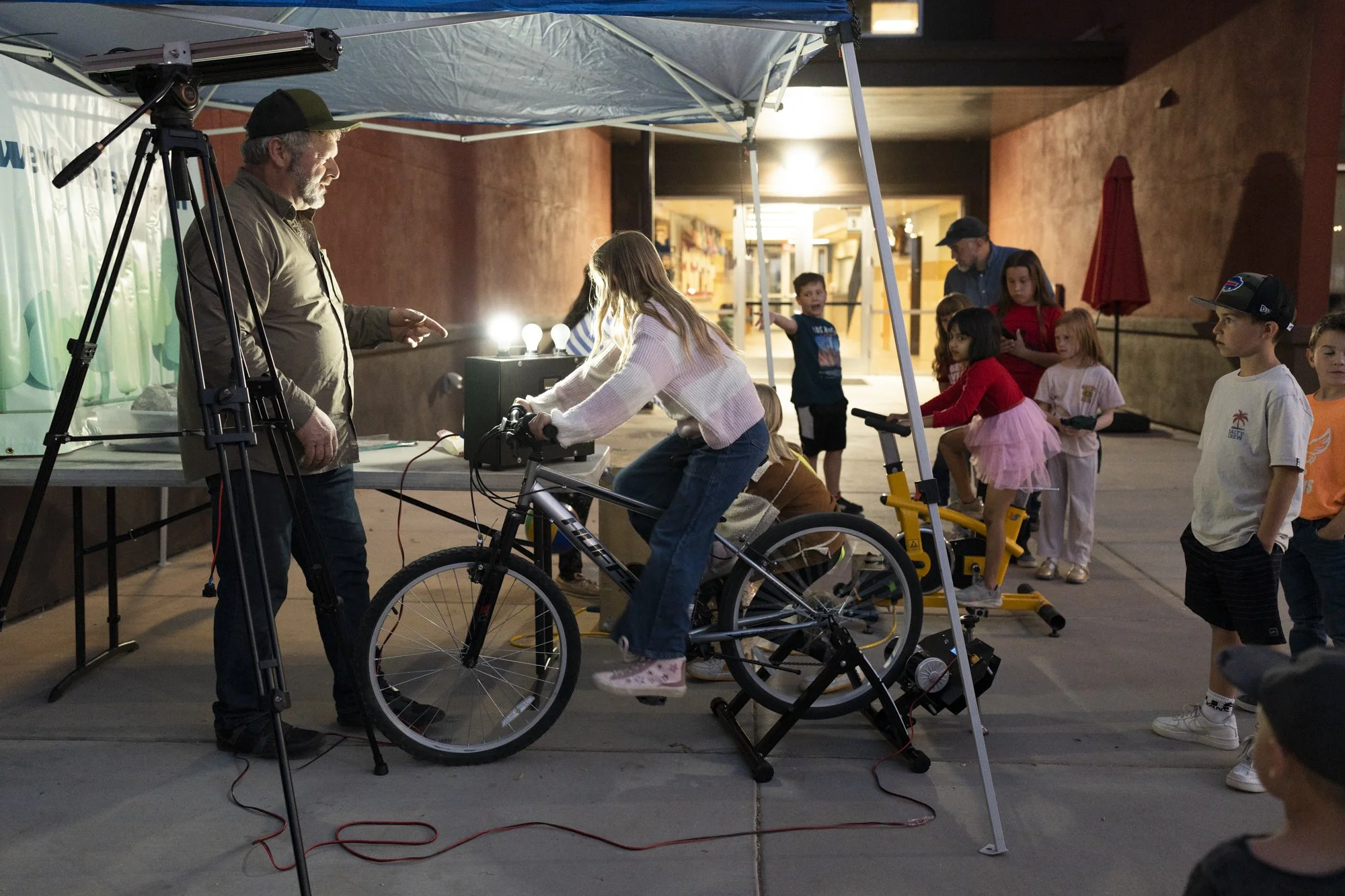outdoor bicycle generator powering a stem light display for kids at an elementary school