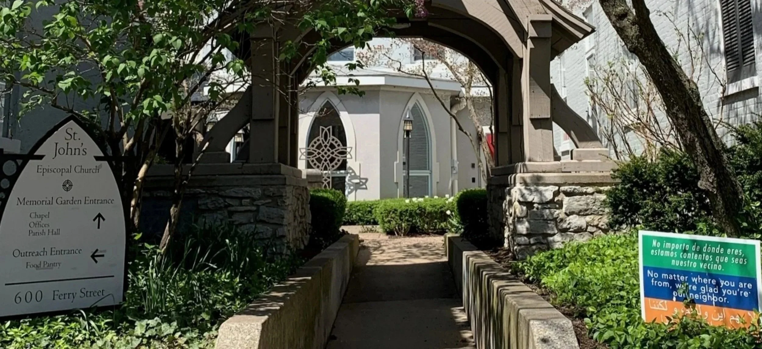 The outside of a church with large, stained glass windows.
