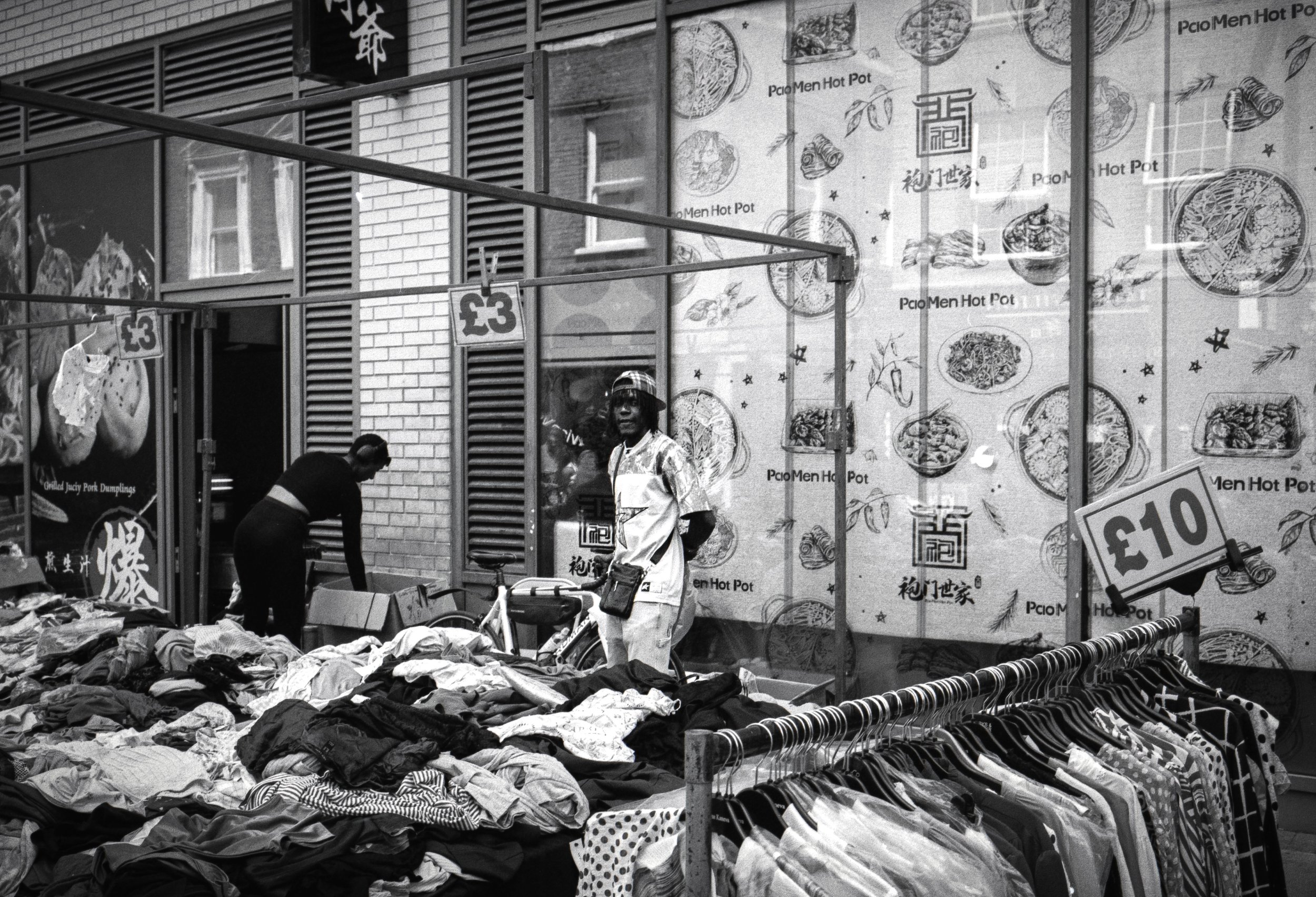 STANDING BY THE WALL : Brick Lane,
July 2026. OM2 | TMax 400 (rated 640)  | 35mm at f11