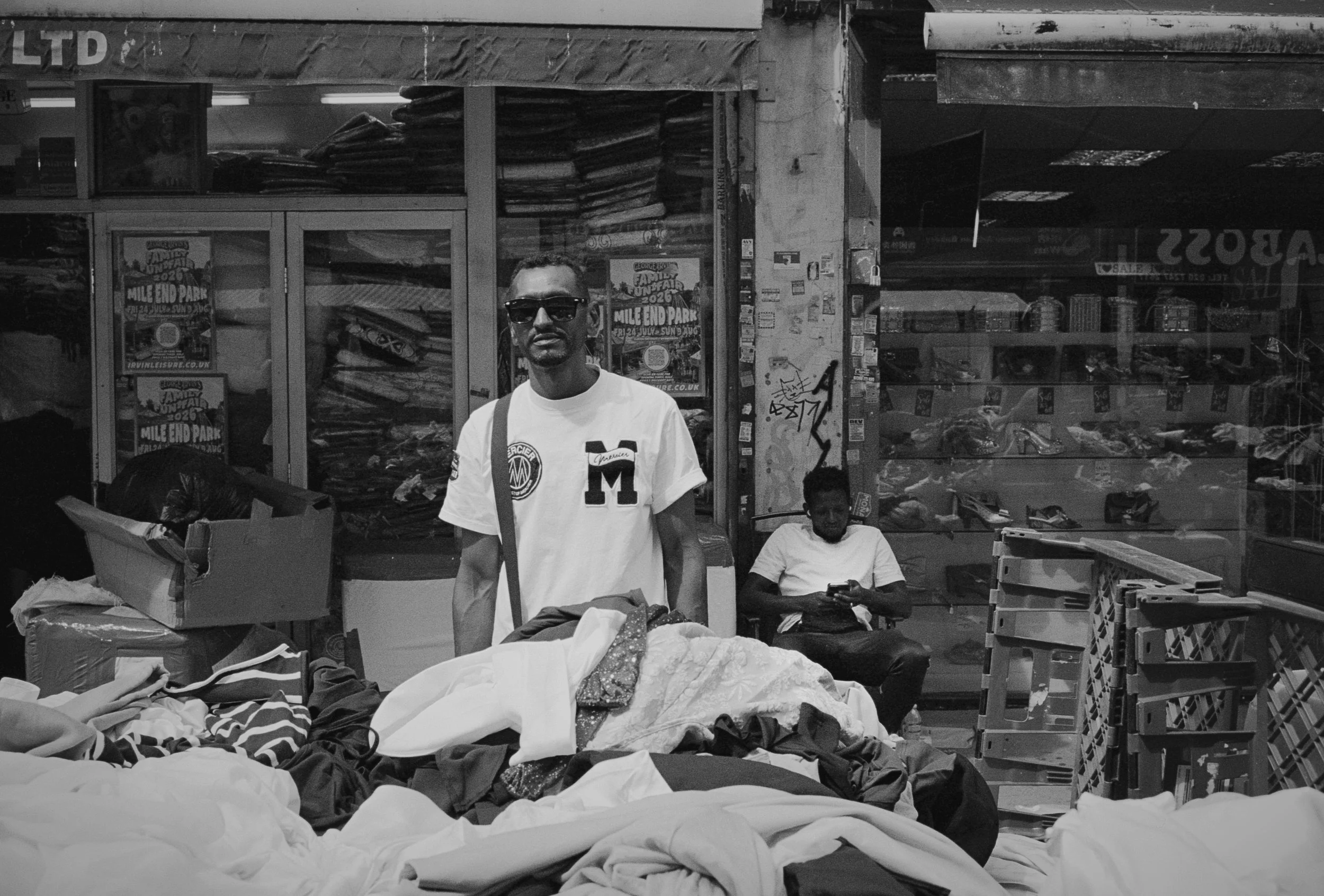 BY THE STALL : Petticoat Lane,
August 2026. OM2 | TRI-X  (rated 640)  | 35mm at f11