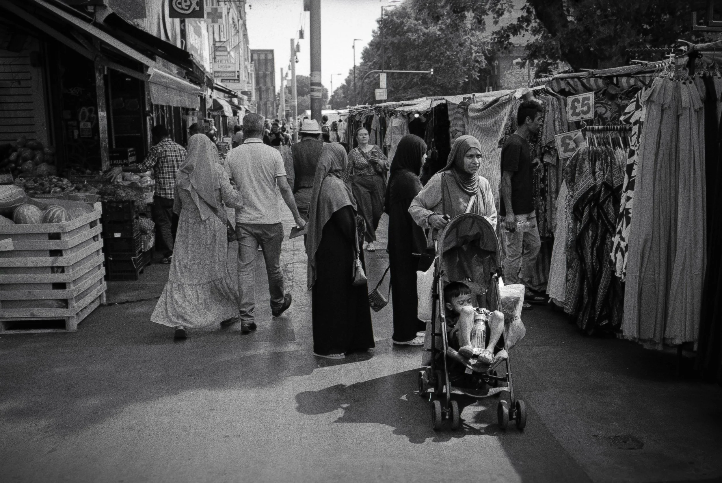 WITH CHILD : Whitechapel Market,
July 2026. OM2 | TRI-X  400 (rated 800)  | 35mm at f11