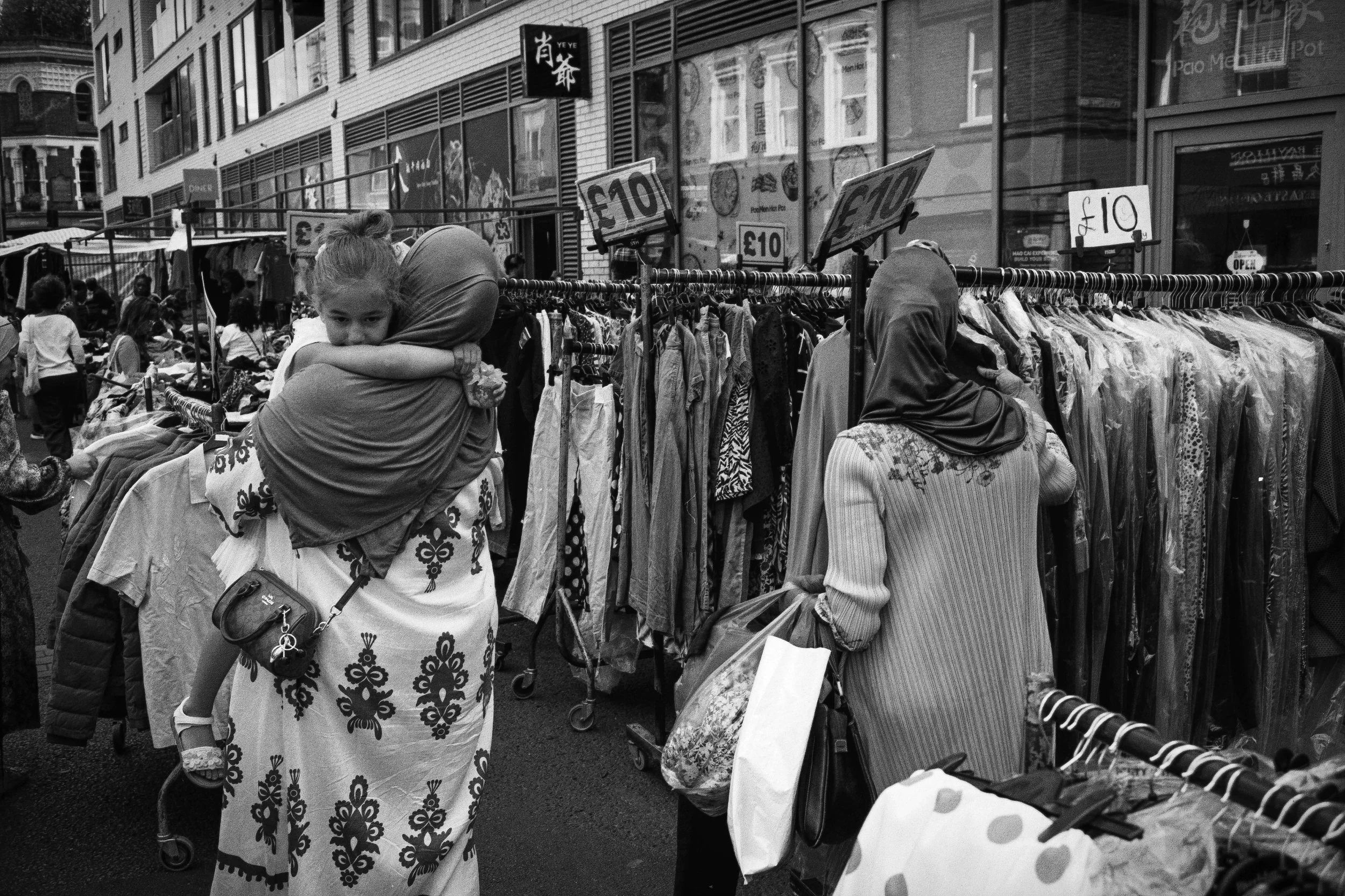 CARRYING CHILD : Petticoat Lane,
August 2026. OM2 | TRI-X  (rated 640)  | 35mm at f11