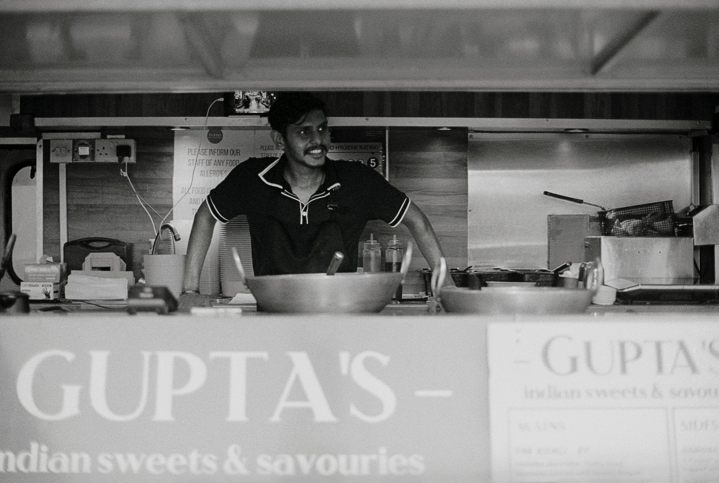 GUPTAS : Spitalfields,
August 2026. OM2 | TRI-X  400 (rated 640)  | 50mm at f11