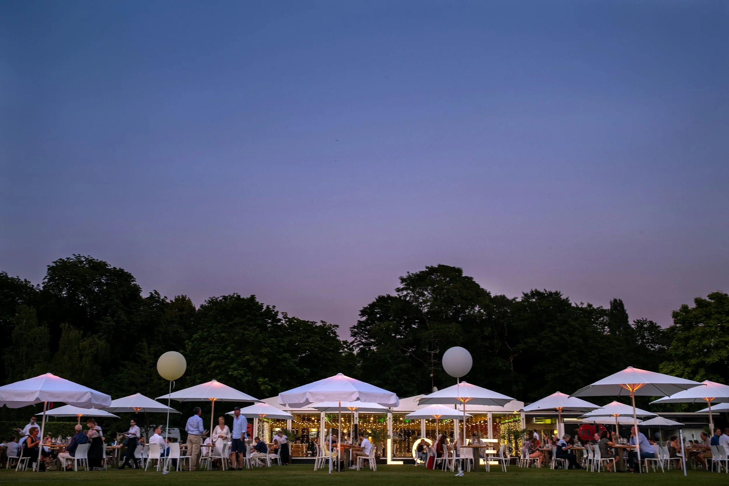 Festival event with white tent rentals, guests, balloons, table and chair rentals.