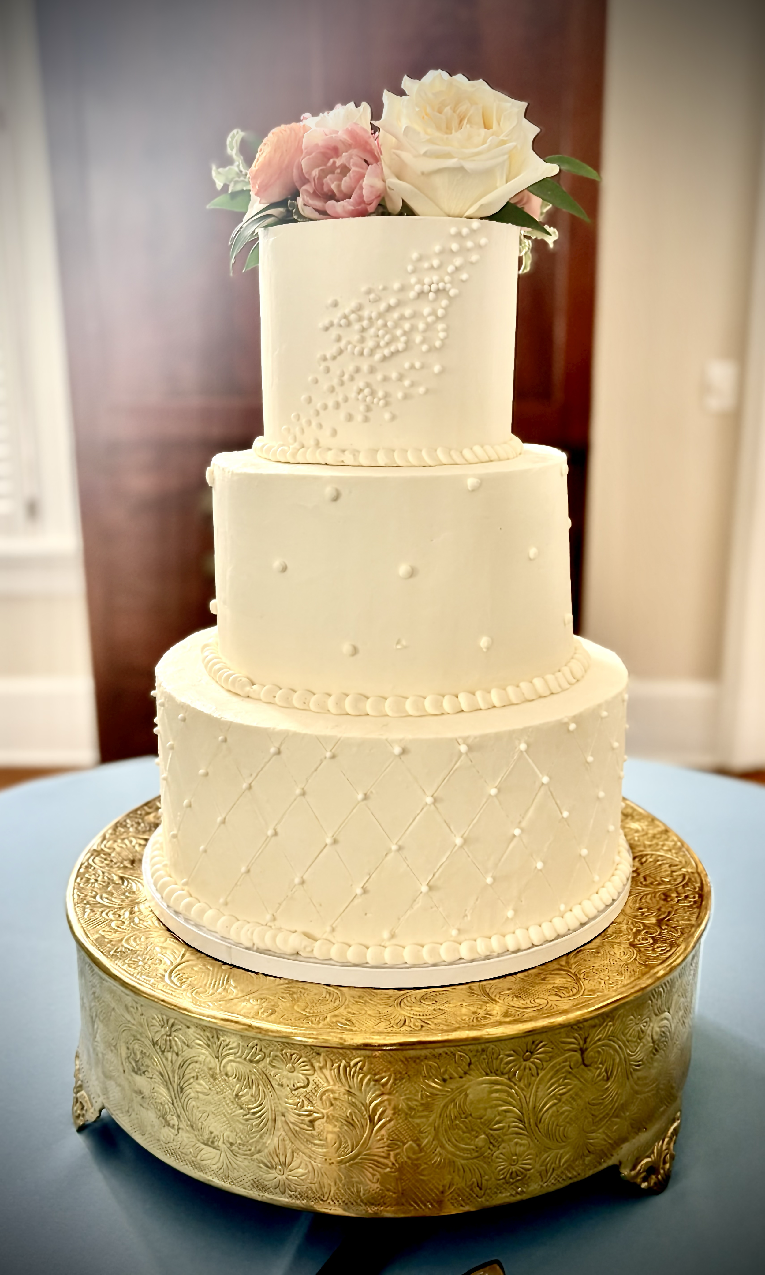 Three tiered pearl and lattice wedding cake