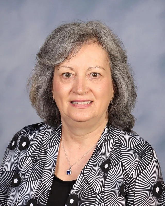 A shield-shaped emblem with a stylized Congress of Chicago logo featuring the letters 'C' and 'C' with arrows, representing the background of the organization.