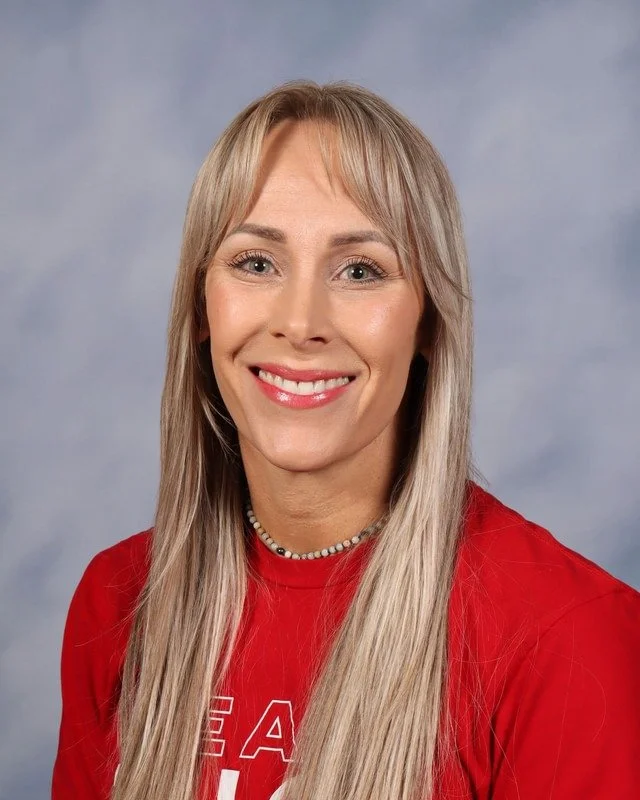 A navy blue shield with a crossed sword and spear, and a central circular emblem with the letters 'GC'.