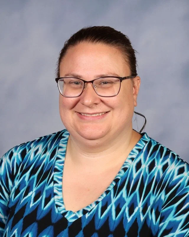 A shield emblem with a blue background and a central logo featuring intertwined letters 'C' and 'K' with crossed arrows, and a lightning bolt above the letters.