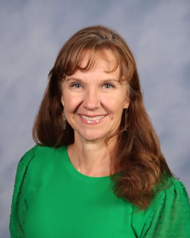 A shield-shaped logo with a monogram of the letters C and M, featuring a sword crossing through the letters, all in shades of blue.