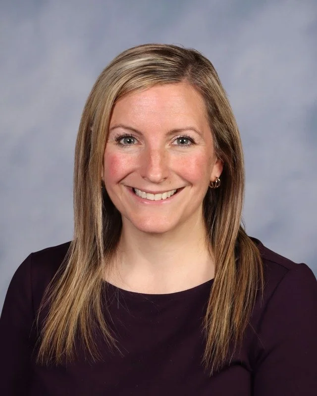 A blue shield with a stylized logo composed of the letters V, C, and A in a circular design.