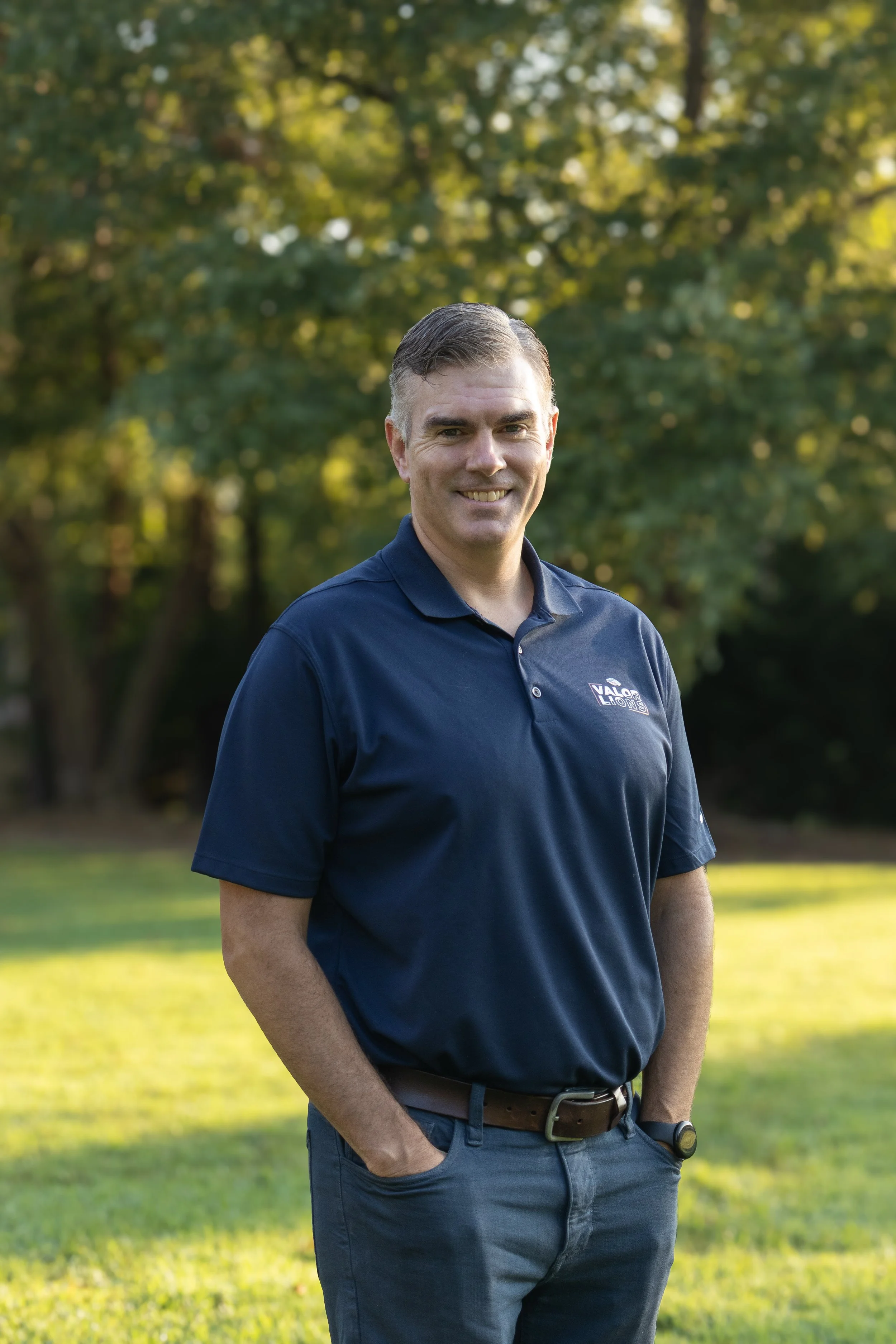 A blue shield with a black and white logo featuring stylized letters V, C, and A.