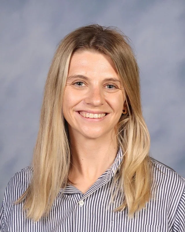 A shield with a dark blue background featuring a central emblem with stylized letters 'V' and 'C' and a lightning bolt, all in a metallic or silver color.