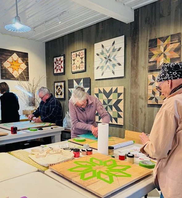 students painting barn quilts.jpg