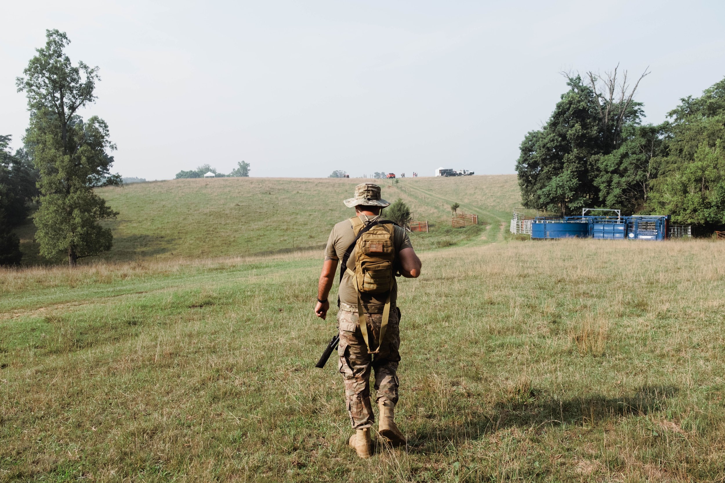 A militiaman with a designated marksman rifle walking to a sniper position. July 18, 2026.