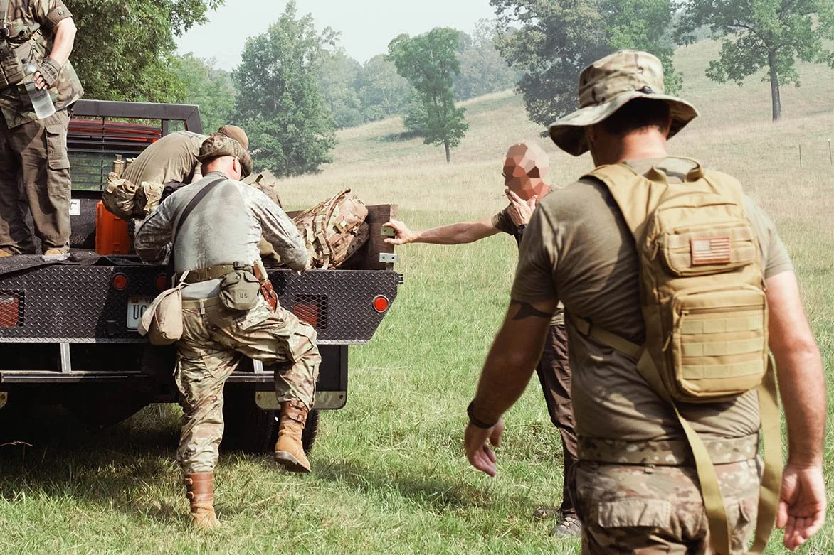Members of the militia load onto a truck to drive around the training ground. July 18, 2026.